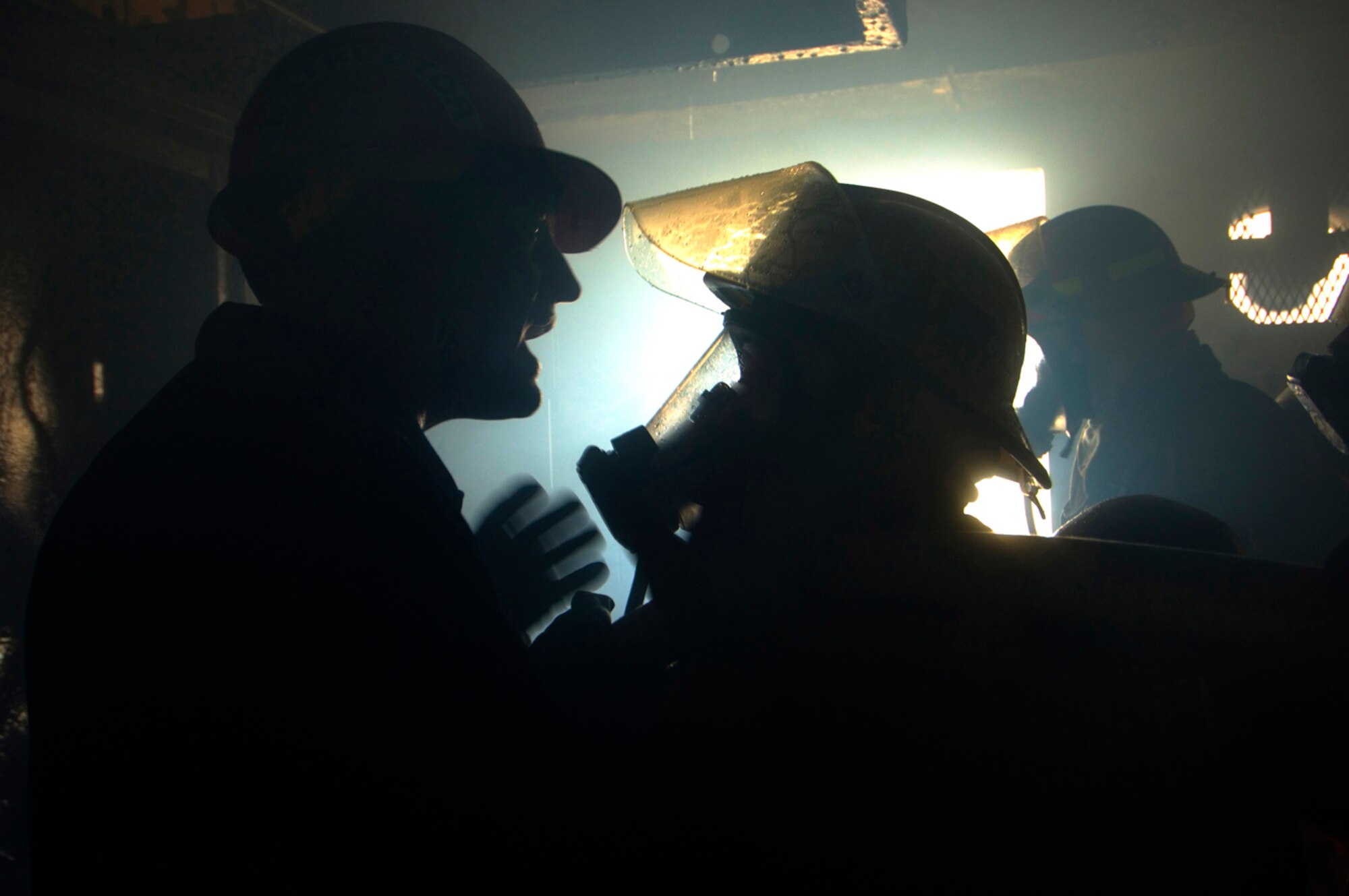 Are your ears burning? Tech. Sgt. Luis Ortiz-Acevedo instructs Staff Sgt. James Kennedy on battling blazes inside buildings. (Photo by Tech. Sgt. Matthew Hannen)