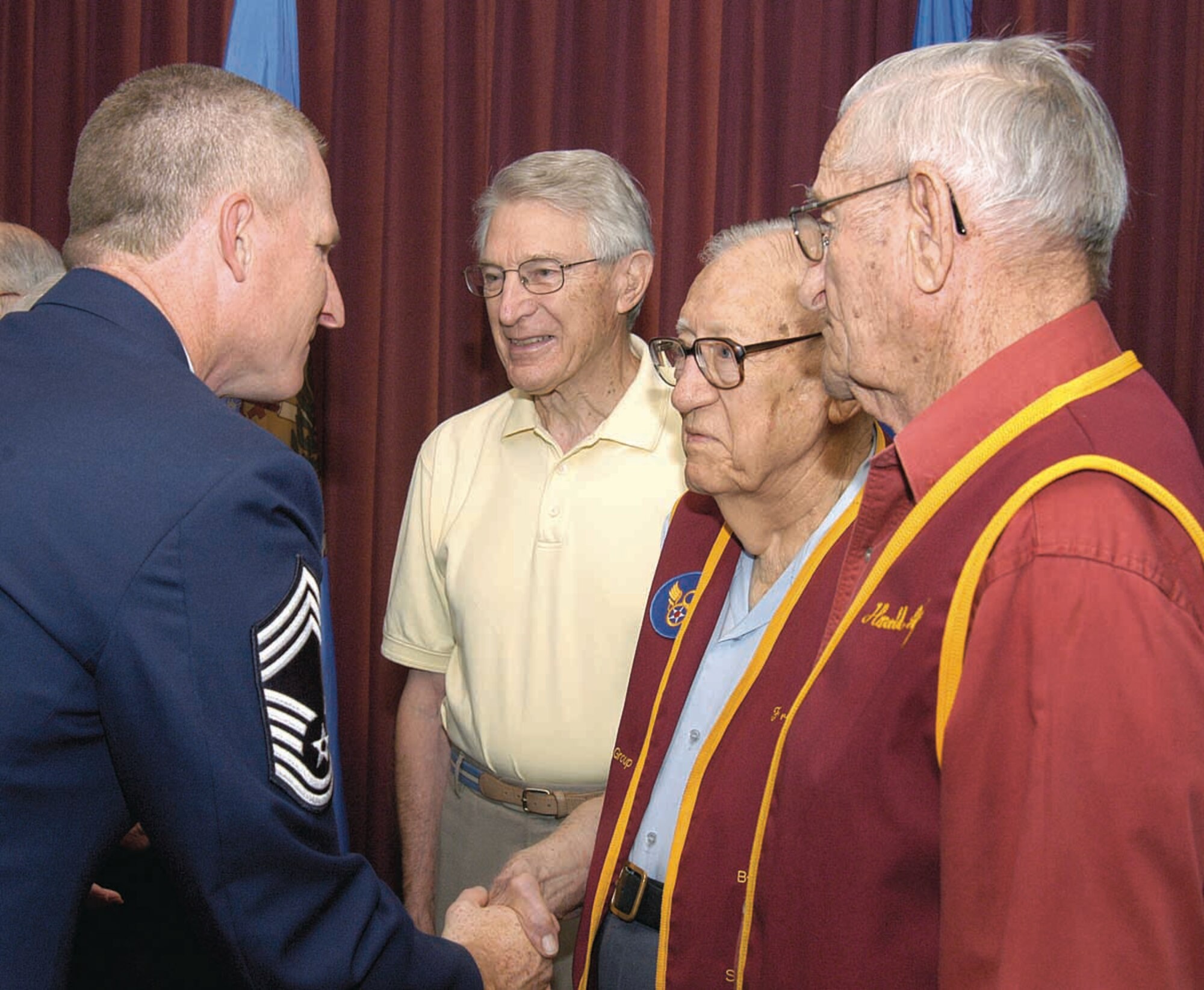 Chief Master Sgt. Roddy Hartsook visits with World War II ex-prisoners of war, guests at the POW/MIA Day Breakfast Sept. 21 in the Tinker Club.  From left are; Melvin Spencer, Air Force captain and B-17 navigator held in Stalag Luft One, Barth, Germany, from 1944 to 1945; Air Force lieutenant and navigator Fred Bird, held in Stalag Luft Three, Germany, from 1943 to 1945; and Army sergeant Harold Angell, an infantryman held prisoner in Repido River Crossing, Italy from 1944 to 1945. (Air Force photo by Margo Wright)