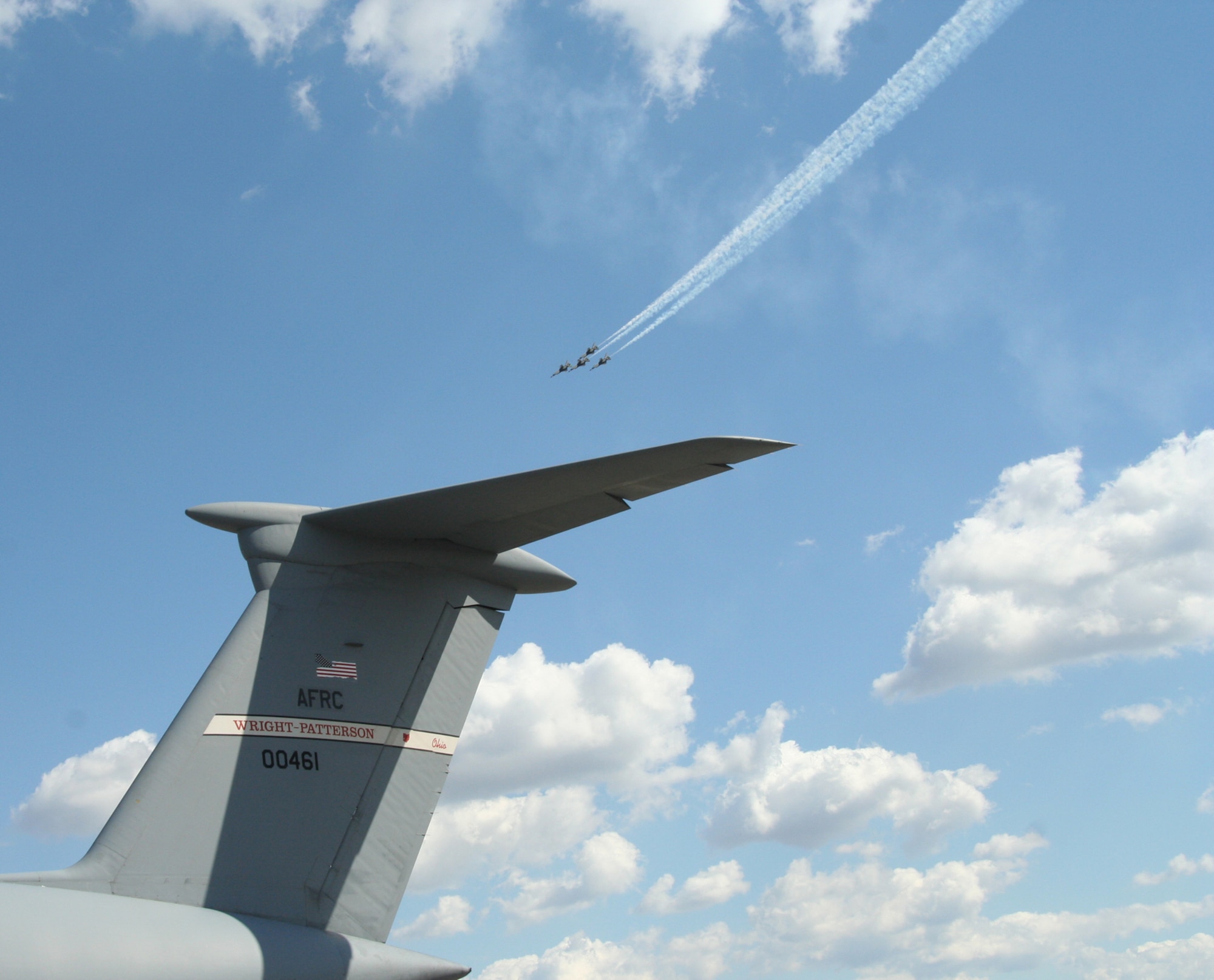 Rickenbacker Air National Guard Base, Columbus, Ohio -- Air Force Thunderbirds aerobatic team streaks by the tail of a C-5 Galaxy aircraft from the 445th Airlift Wing from Wright-Patterson AFB, Ohio during the Gathering of Mustangs and Legends air show Friday, September 28, 2007. (U.S. Air Force photo/Maj. Ted Theopolos)