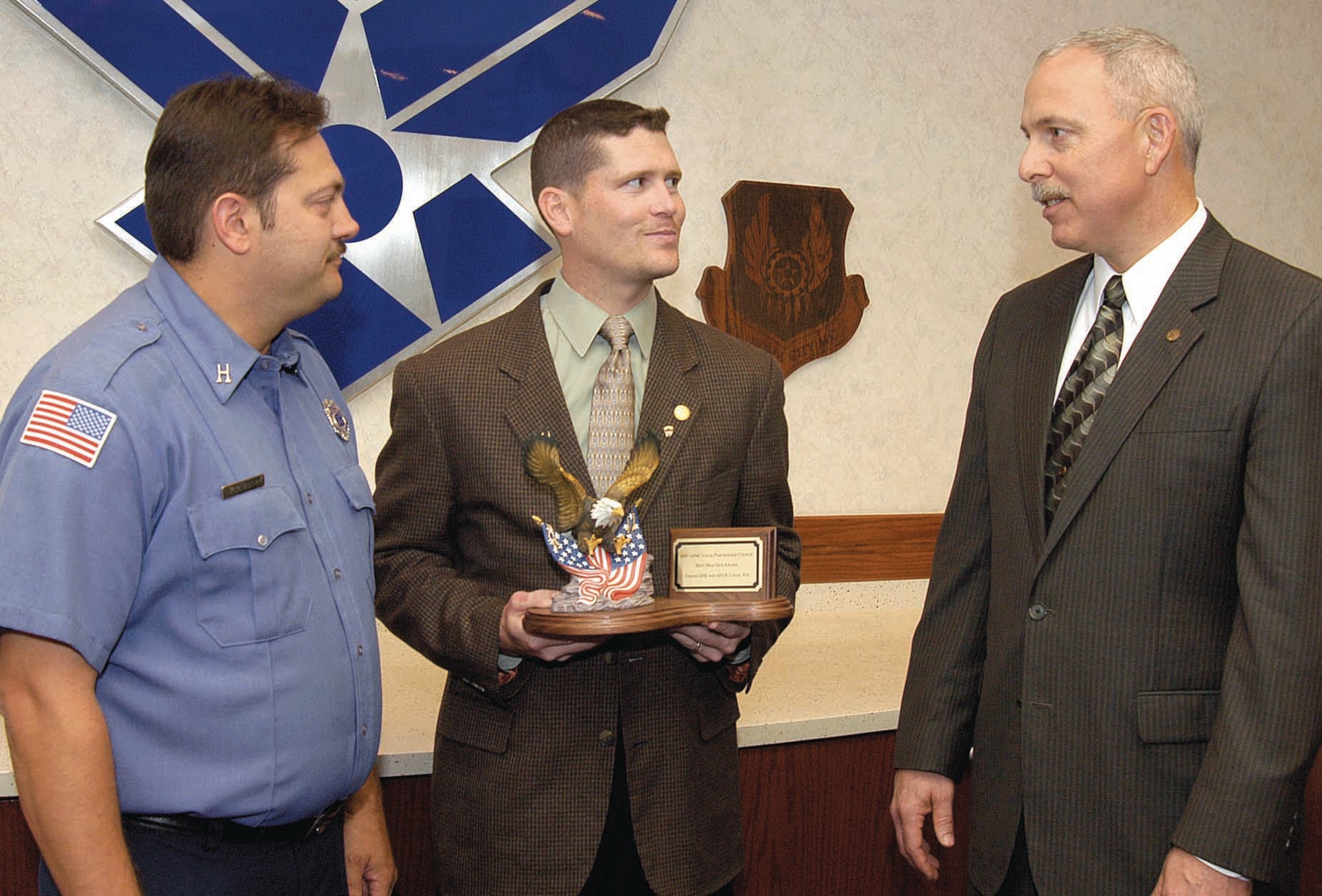 Efforts by union and Tinker leadership for continuing successful relationships has earned recognition by Air Force Materiel Command.  The AFMC Local Partnership Best Practice Award, presented at AFMC recently, is the subject of conversation for, from left; Todd Lambert, International Association of Firefighters, F-211 president; James Schmidt, AFGE Local 916 president; and John Over, Oklahoma City Air Logistics Center executive director. (Air Force photo by Margo Wright)
