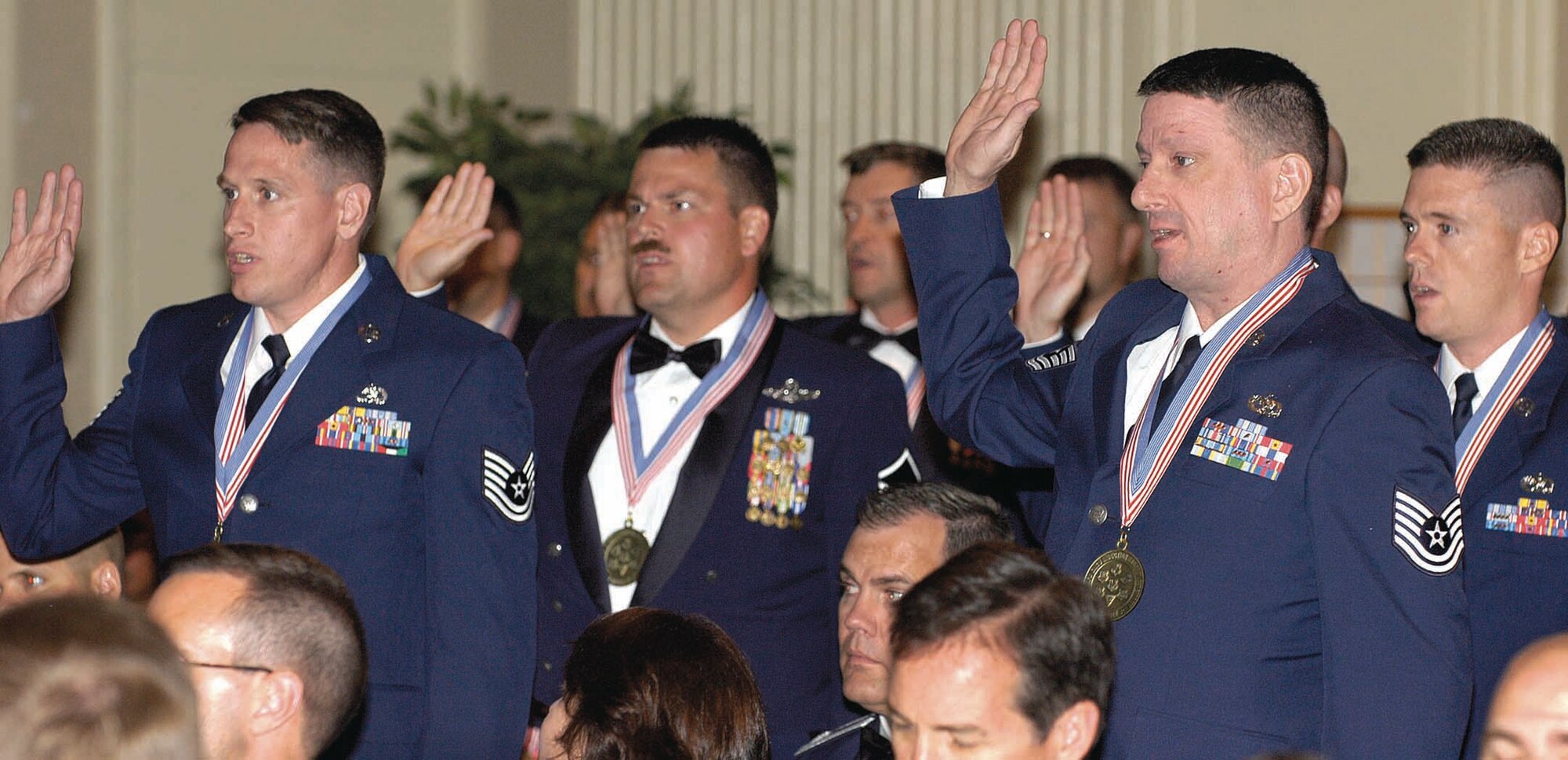 Eighty-three Airmen repeat a senior noncommissioned officer charge, symbolizing their achievement and new responsibilities, during the Sept. 21 SNCO Induction Banquet. (Air Force photo by Margo Wright)


