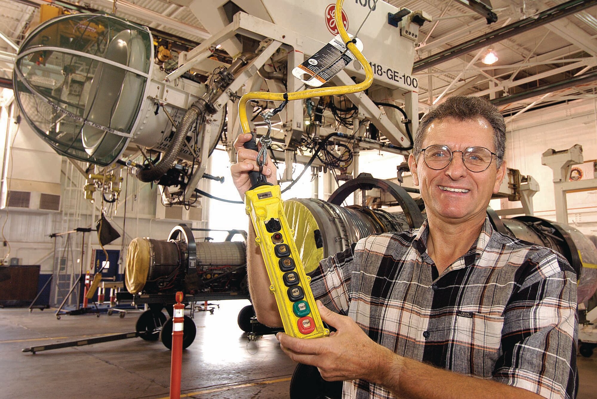 Ray Hatleli devised a disconnect system so Engine Test Cell operators could move pendant controls from hanging positions in or outside of test cells, a FOD mishap waiting to happen, and reattach it in a safe location.  The new method earned him an IDEA cash award. (Air Force photo by Margo Wright)
