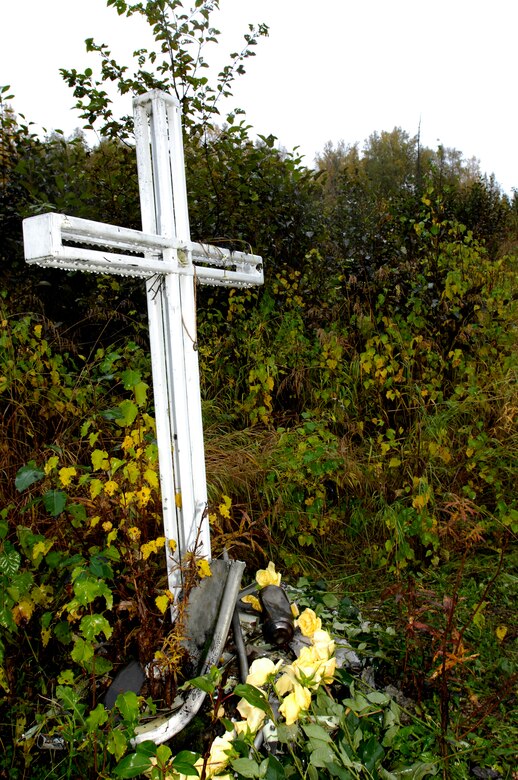 A memorial for the crew of Yukla 27 remains at the crash site. Family and squadron members held a memorial for the crew Sept. 21. A six-foot cross has been placed to mark the site.