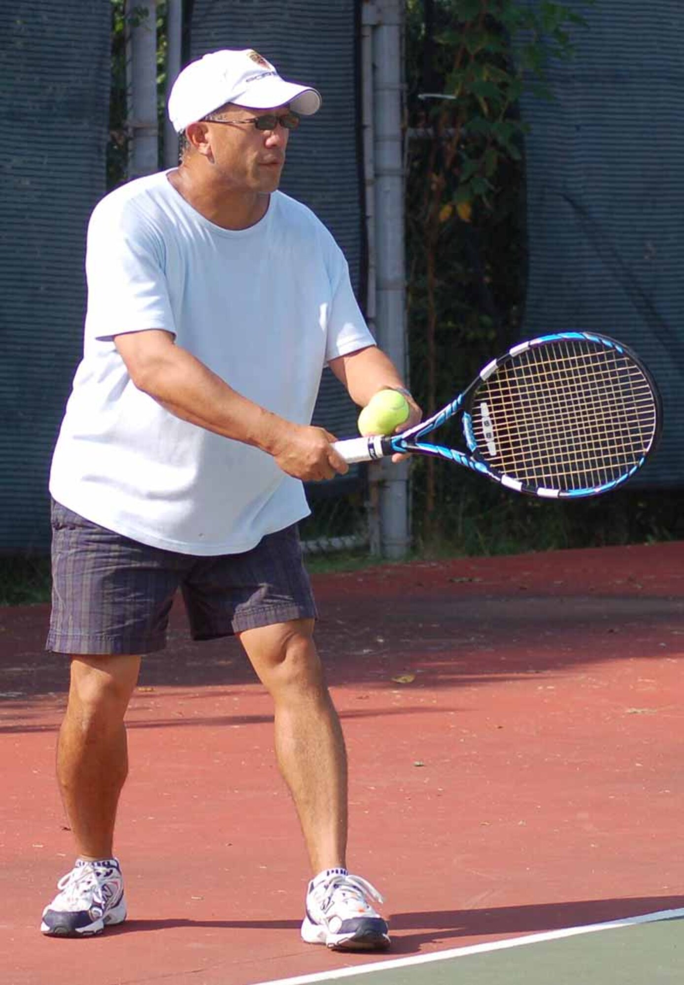 Thanh Alcorn prepares to serve the championship in the over-35 men's division of the intramural tennis championship Sept. 22. (Air Force photo by John E. Banks)
 