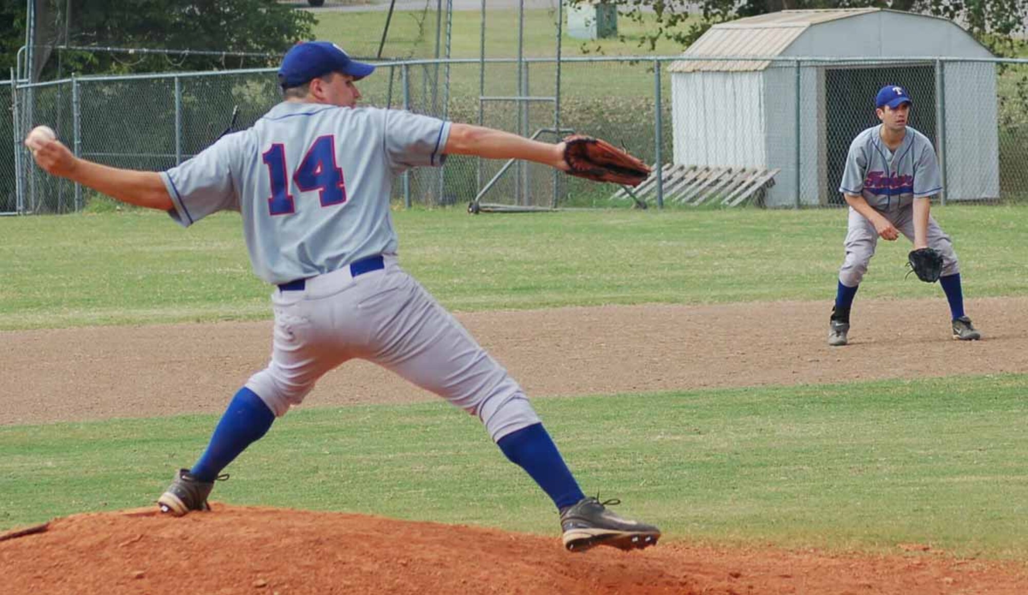 Tinker Rangers pitcher Steven Escalante delivers a fastball in the second inning as first baseman Caleb Gray watches during a playoff game against Team Dynasty on Sept. 23 at Hillsdale College in Moore. (Air Force photo by John E. Banks)