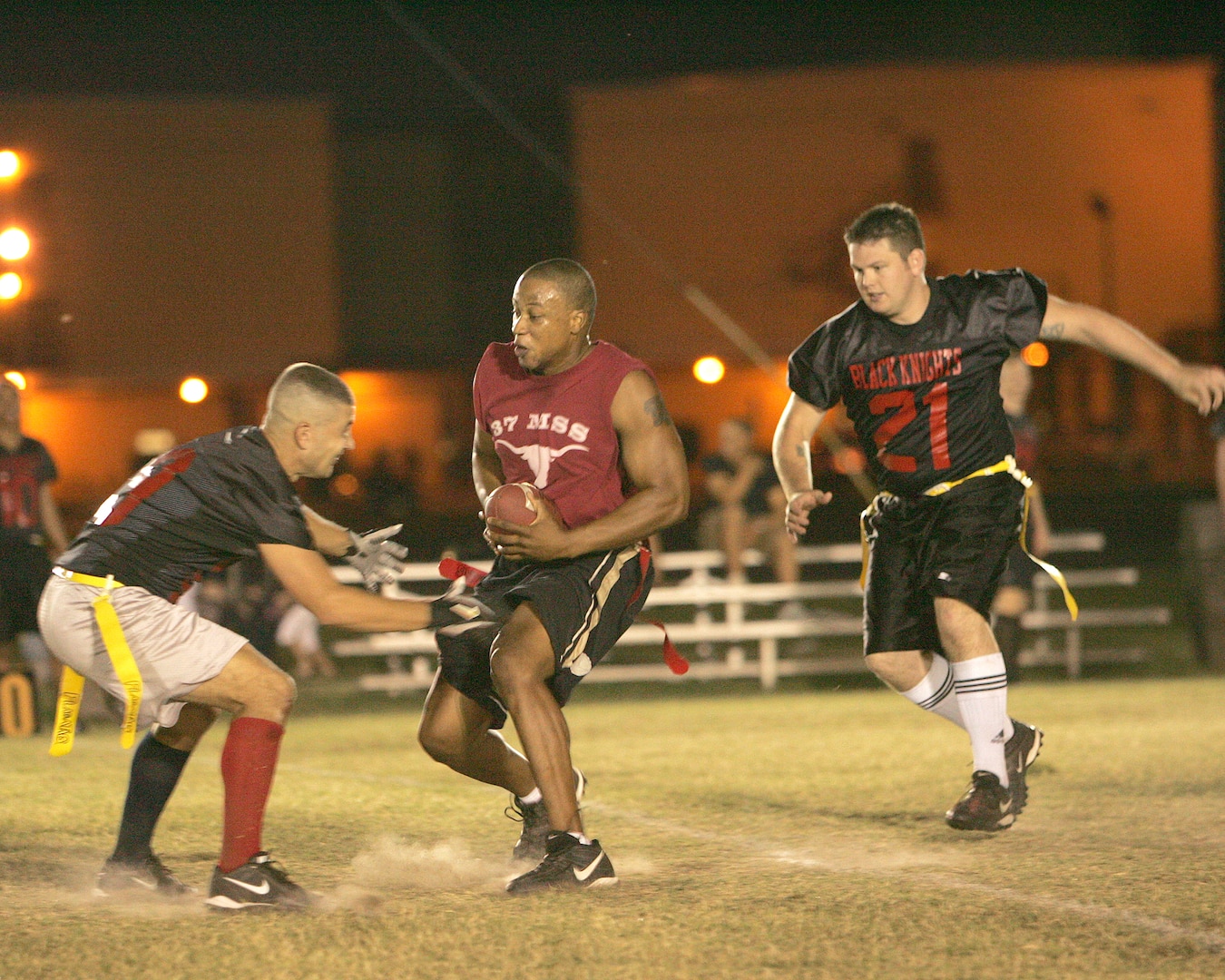 37th Mission Support Squadron receiver Shad Clark tries to evade two defenders from the 93rd Intelligence Squadron in the Sept. 24, 2007 game at Lackland Air Force Base, Texas. (USAF photo by Robbin Cresswell)