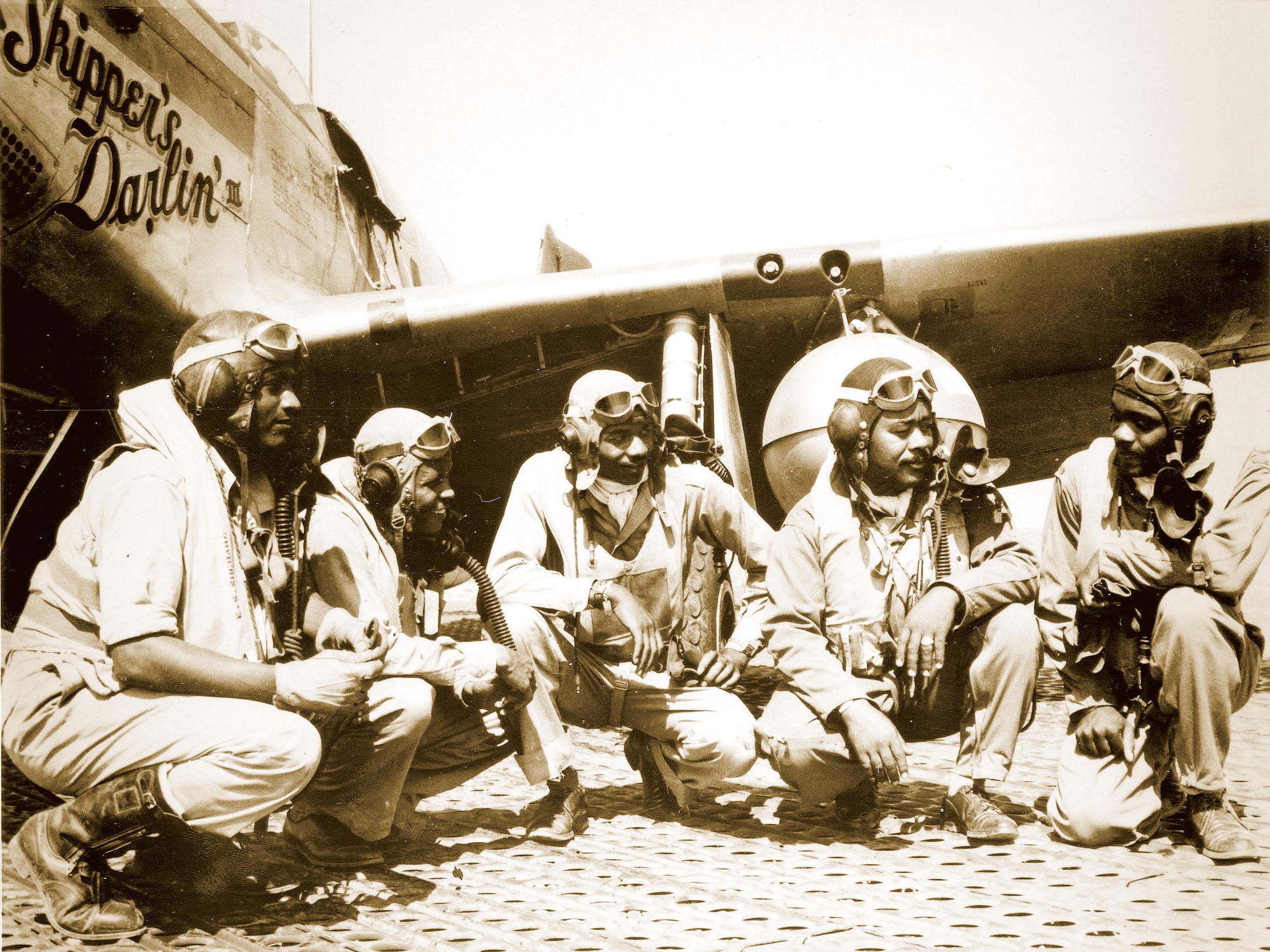 Pilots of the 332nd Fighter Group, "Tuskegee Airmen," the elite, all-African American unit, pose at Ramitelli, Italy: (from left to right) Lt. Dempsey Morgan, Lt. Carroll Woods, Lt. Robert Nelson Jr., Capt. Andrew D. Turner, and Lt. Clarence Lester. 