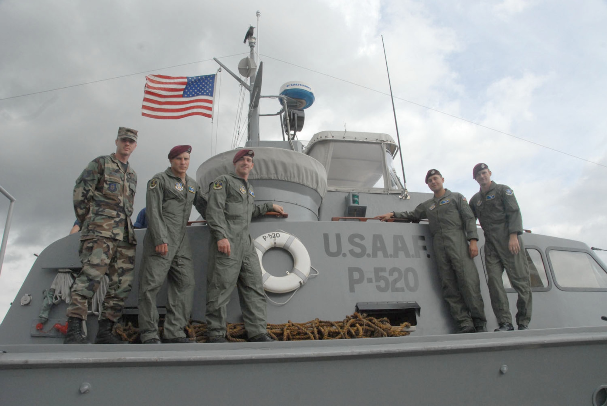 Air Force Reserve Airmen from the 304th Rescue Squadron, pose for a shot on top of a rescue relic, a P-520 Crash Boat. (Air Force photo/Master Sgt. Chance C. Babin)