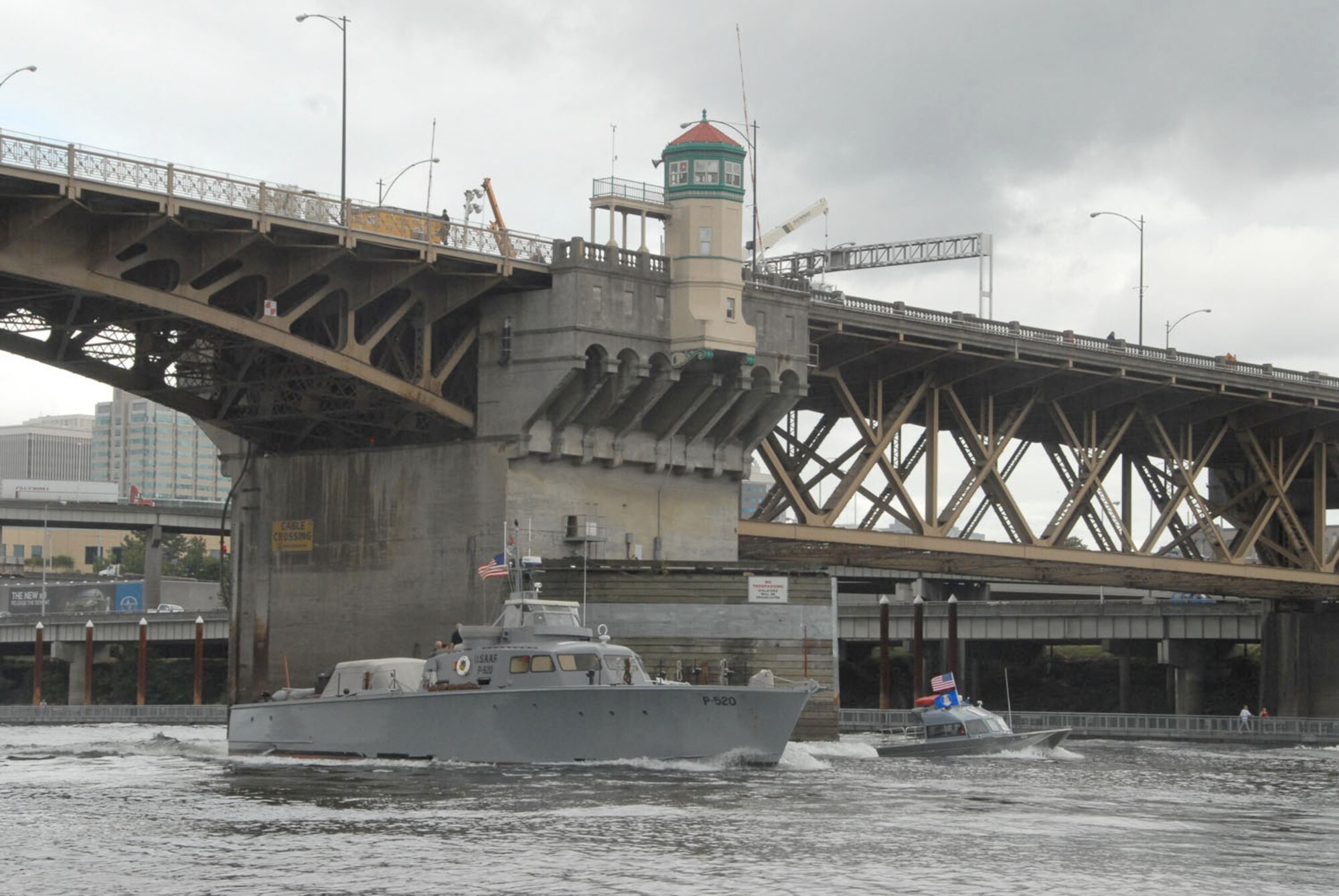 A WWII era P-520 crash/rescue boat arrives along the Willamette River in downtown Portland, Ore., escorted by members of the Air Force Reserve's 304th Rescue Squadron. The P-520 was part of the Army Air Force's early rescue system that gave birth to the modern day combat search and rescue. (Air Force photo/Master Sgt. Chance C. Babin)