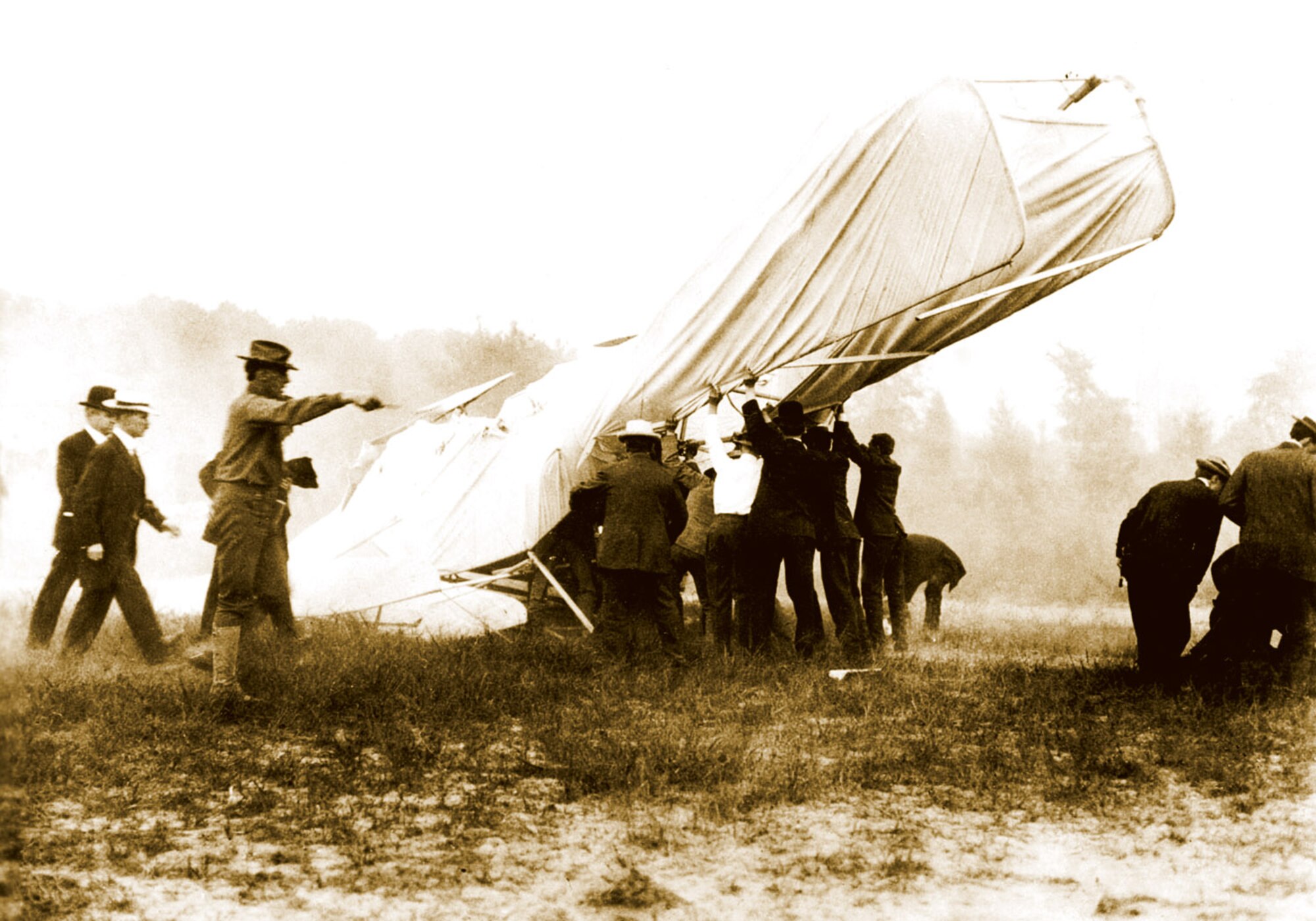 Bystanders help remove mortally-wounded  Lt. Thomas Selfridge from the wreck of a Wright Brothers Flyer after it crashed during performance tests at Fort Myers, Va., on Sept. 17, 1908. Orville Wright was also injured. 