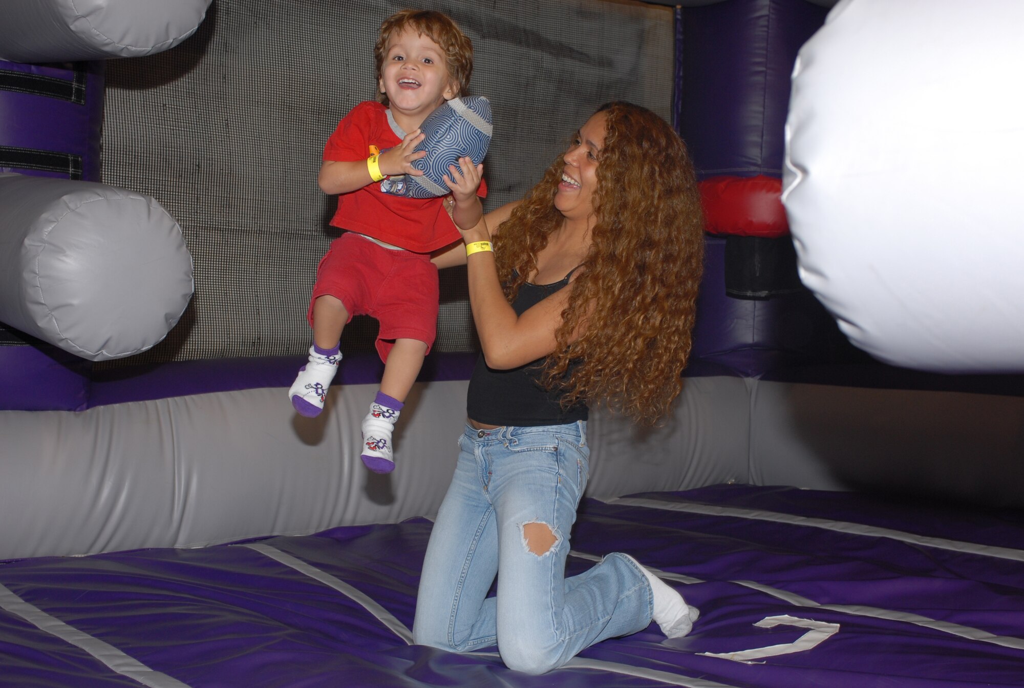 Emilio Munoz, 2, and his mother, Lydia, share a good time at the July 21 Hearts Apart meeting held at Bounce U in Goodyear, Ariz. (photo by Staff Sgt. Ian Dean)