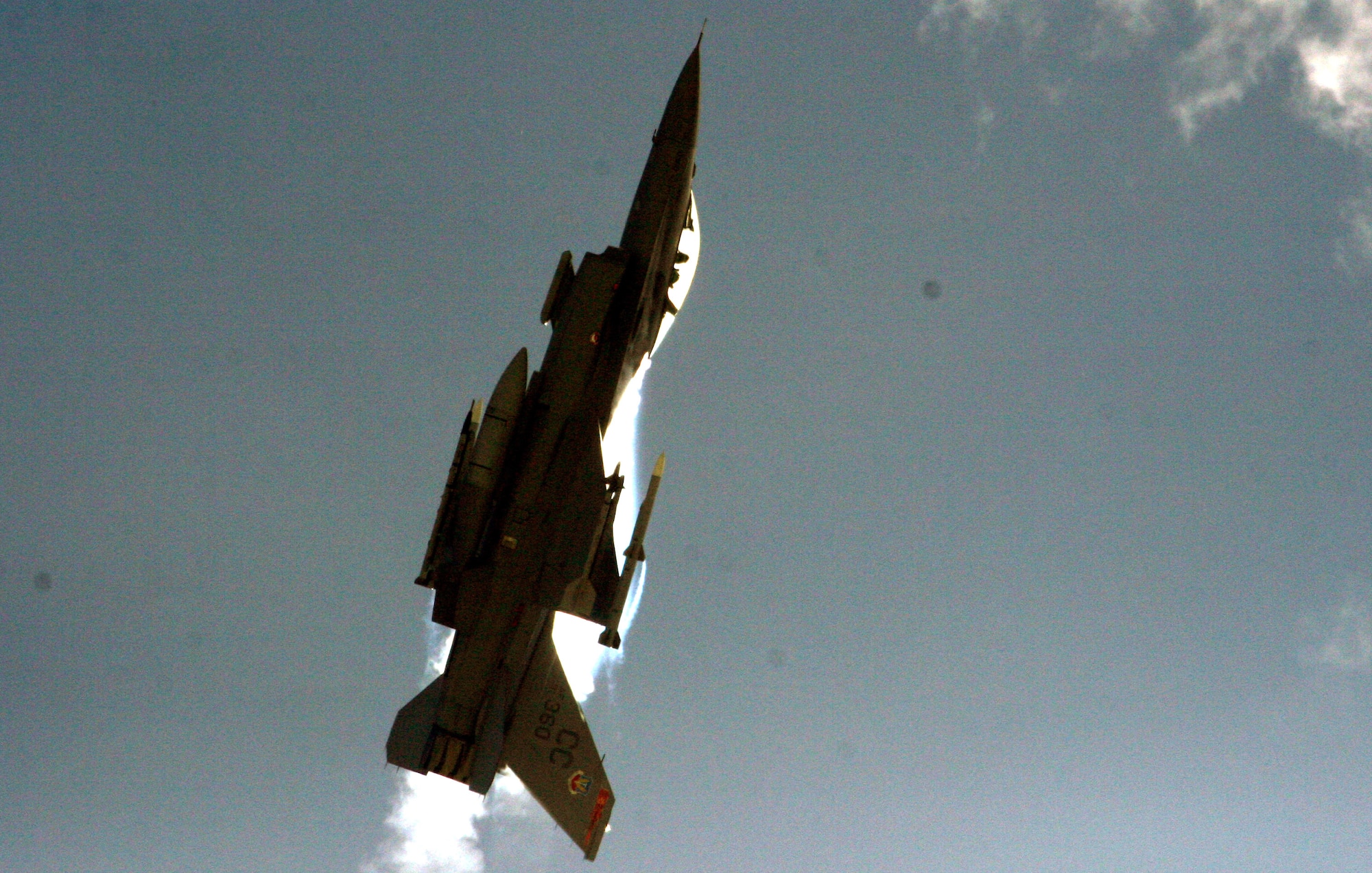 An F-16 Fighting Falcon demonstrates its range of maneuverability during an aerial intercept exercise Sept. 24 at Andersen Air Force Base, Guam. The F-16 C/D model is capable of withstanding up to nine Gs, or nine times the force of gravity, during combat maneuvers. (U.S. Air Force photo/Senior Master Sgt. Mahmoud Rasouliyan)