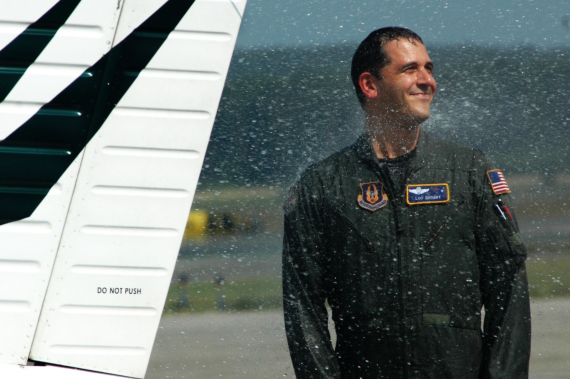 Lt. Col. Lou Shogry enjoys a good soaking amid the New England heat and humidity following his fini flight earlier this summer. Colonel Shogry, former commander of the 337th Airlift Squadron, is now the Emergency Preparedness Liaison Officer with the Federal Emergency Management Agency. (US Air Force photo/Senior Airman Michael Lanza )