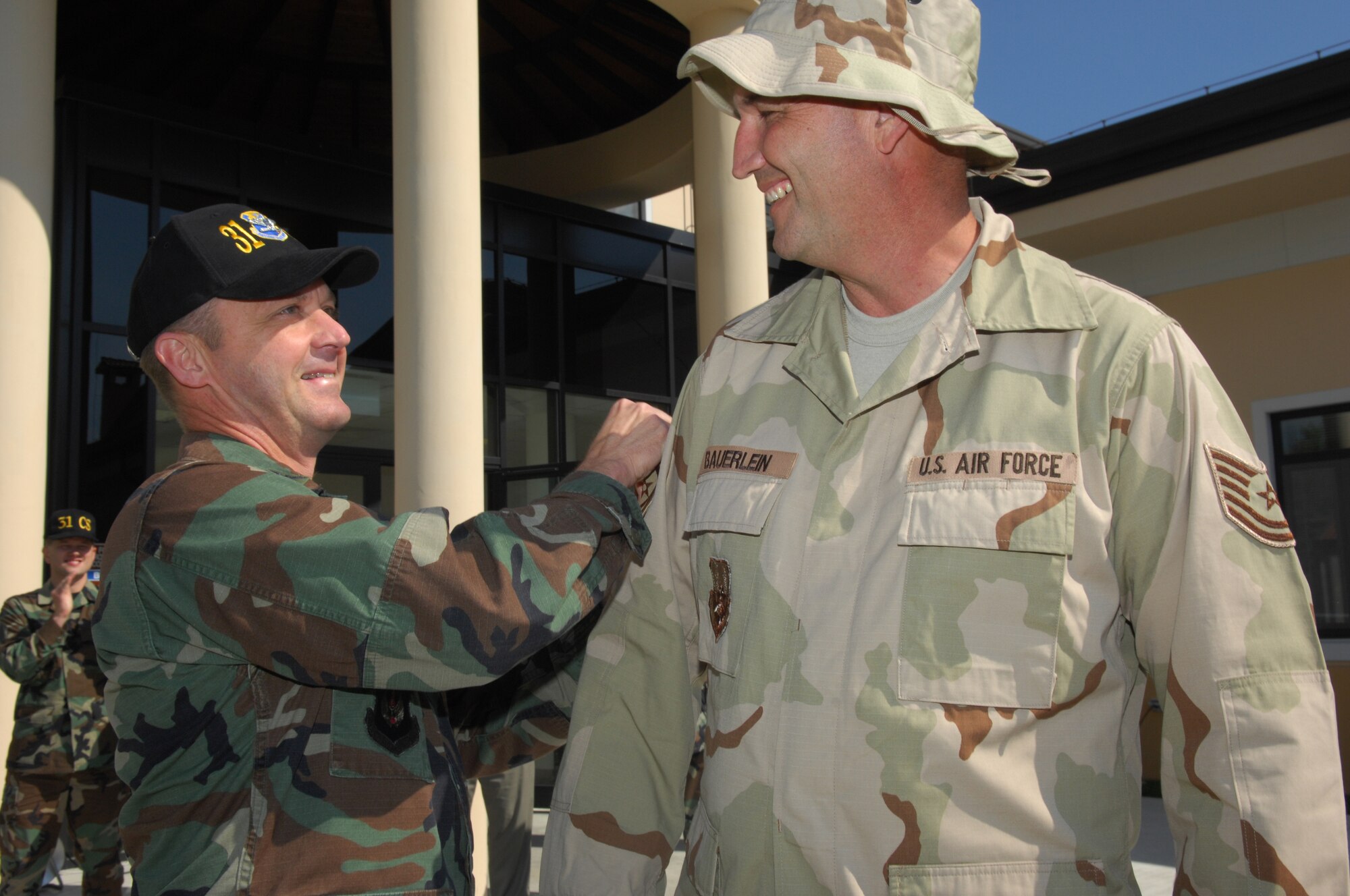 AVIANO AIR BASE, Italy--Tech. Sgt. George Bauerlein, 31st Communications Squadron, receives a celebratory tap on the sleeve from Col. Monty Brock, 31st Fighter Wing vice commander, after being presented a set of master sergeant stripes here Sept. 20. (U.S. Air Force photo/Staff Sgt. Michael R. Holzworth)