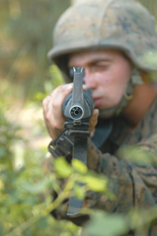 A recruit scans the area and provides cover for his fellow recruits during an exercise at the Crucible.