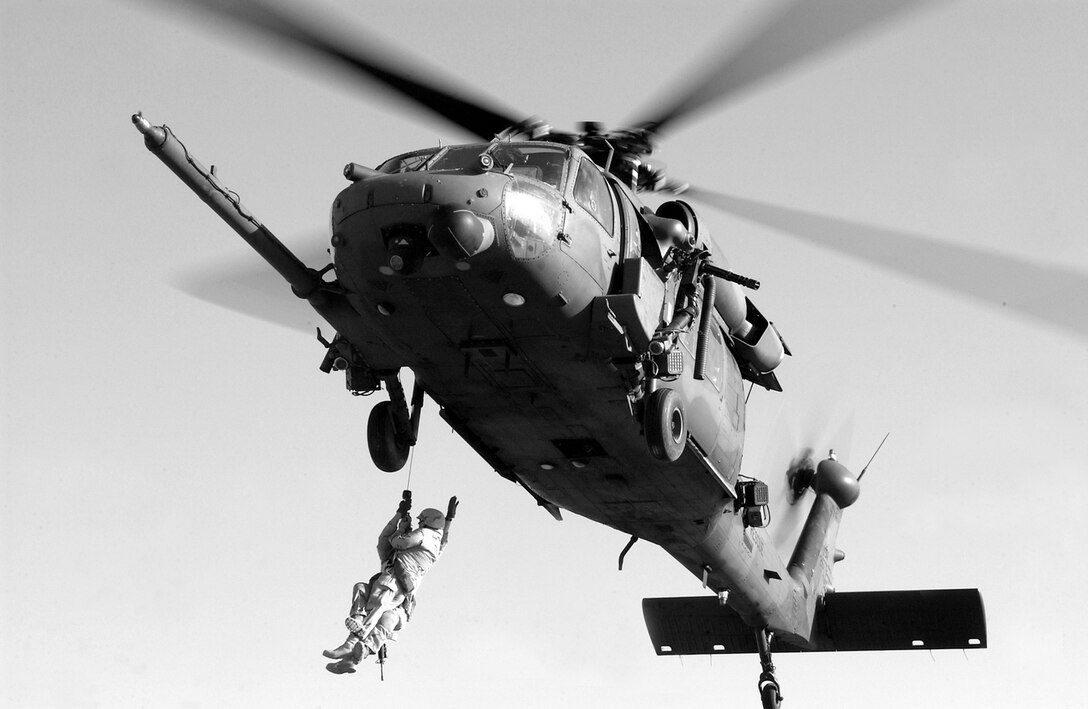 During infiltration training at Baghdad International Airport, Iraq -- Staff Sgt. Gabriel Ruff uses a hoist to raise a "patient" to safety  Ruff is a pararescueman deployed from Moody Air Force Base, Ga.  (U.S. Air Force photo by Staff Sgt. Stacy L. Pearsall)                                                                       