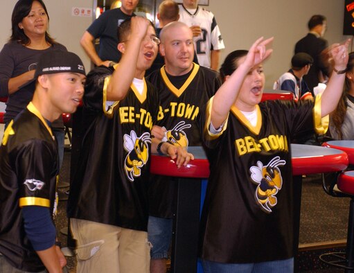 KUNSAN AIR BASE, South Korea -- Airmen from the 8th Medical Group, cheer for a fellow teammate during their bowling game Sept. 28 here. The MDG, along with others, participated in a number of events during the 8th Fighter Wing Sports Day. The sports day allows Airmen a way to compete in friendly and fun competitions, helping to build esprit de corps. The day kicked off with a wing run and events, ranging from a Texas Hold 'Em tournament to unit paintball challenges. (U.S. Air Force photo/Senior Airman Steven R. Doty)                               