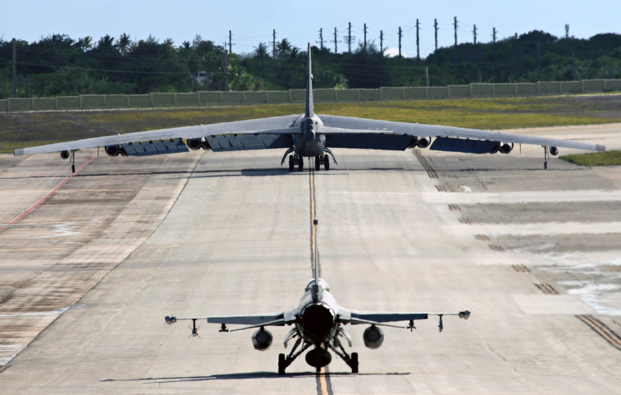 A Fireball F-16 taxies behind a B-52 here on Andersen. Even though this is the last deployment for the Fireballs, they conducted some very valuable and jointly integrated training here with airframes like the B-52. The unit itself is being deactivated but the people that comprise it are not. Because of the intense training conducted by the 522 EFS here, its members are leaving as highly technical and skilled to their respective gaining units. (Air Force photo/Senior Master Sgt. Mahmoud Rasouliyan) 
