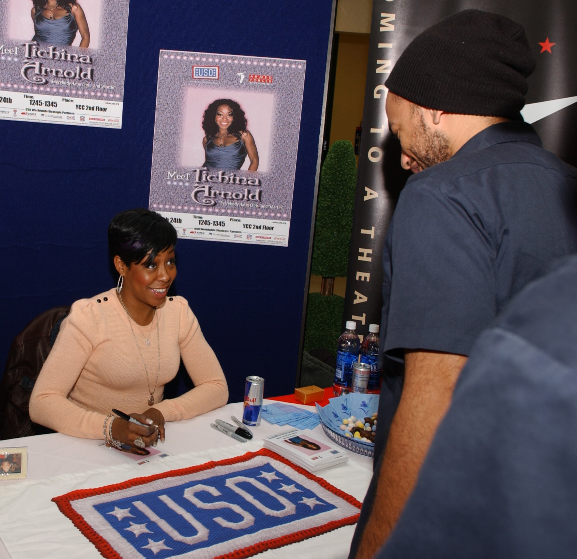 Actress Tichina Arnold, "Everybody hates Chris" and "Martin" signs an autogragh for a fan March 24 at the Yokota Community Center. Ms. Arnold visited base meeting Airmen at the Samurai Cafe and also visiting schools on base. (U.S. Air Force Photo by Airman 1st Class Eric Summers)                                