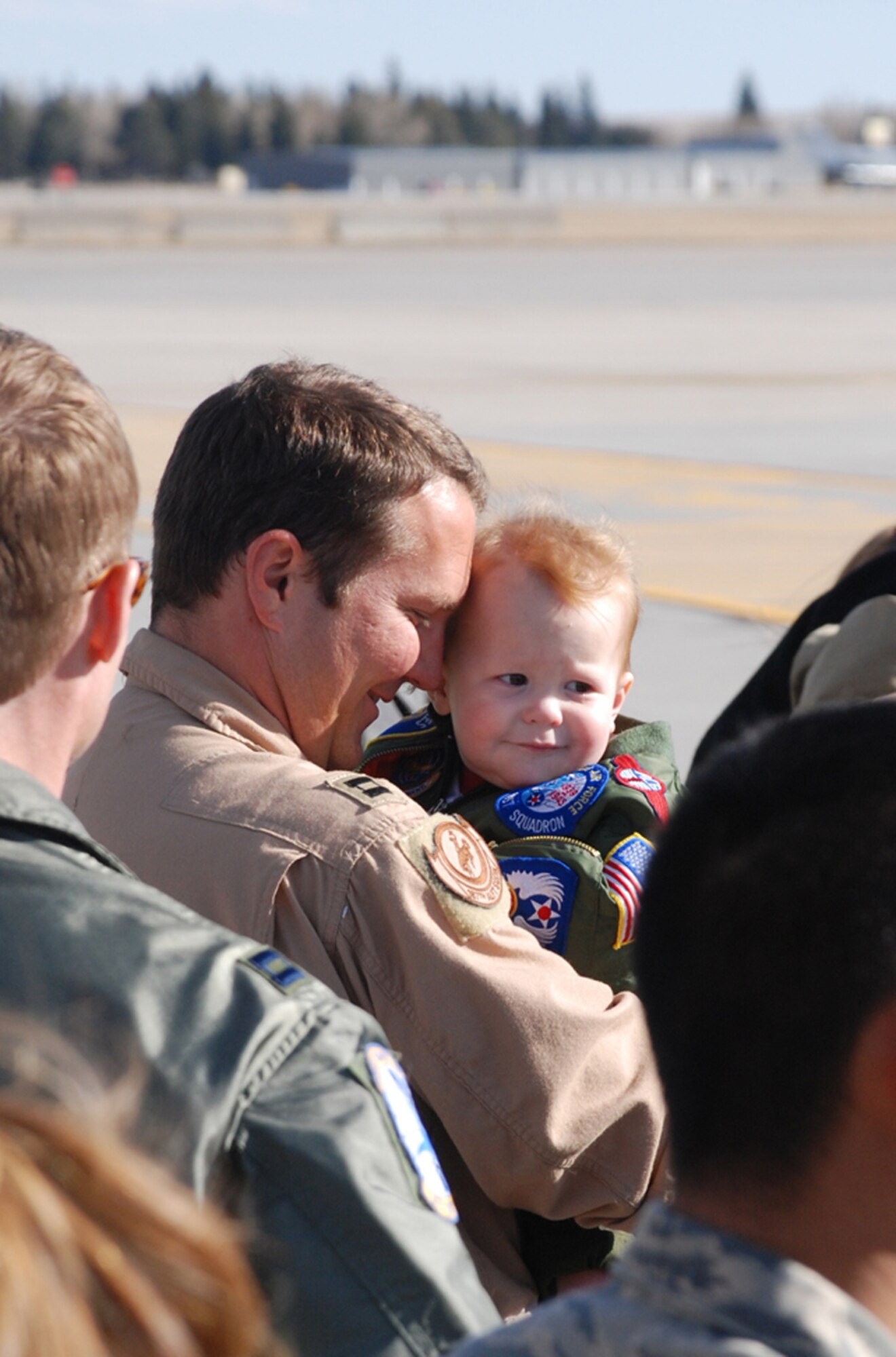 Capt. Brian Diehl, 153rd Airlift Wing, holds his son, Maxwell, March 19 after returning from a 60-day deployment to Iraq. Eleven Airmen from the Wyoming Air National Guard deployed to Iraq supporting airlift operations in the Global War on Terrorism.