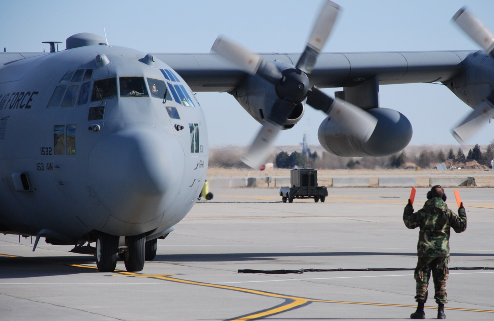 A C-130 Hercules from the 153rd Airlift Wing taxis to park at the Cheyenne Regional Airport March 19. The C-130 is carrying 11 Airmen from the Wyoming Air National Guard that were on 60-day and 120-day deployments to Iraq (U.S. Air Force photos/by Staff Sgt. Chad Thompson).