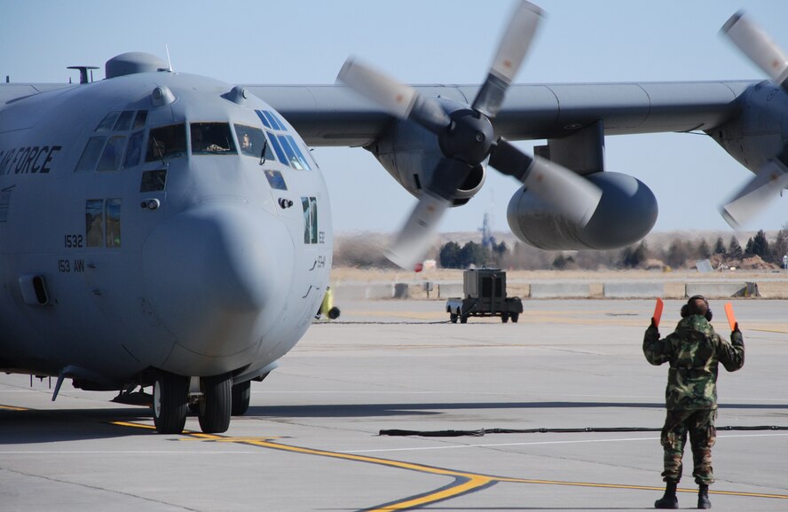 A C-130 Hercules from the 153rd Airlift Wing taxis to park at the Cheyenne Regional Airport March 19. The C-130 is carrying 11 Airmen from the Wyoming Air National Guard that were on 60-day and 120-day deployments to Iraq (U.S. Air Force photos/by Staff Sgt. Chad Thompson).