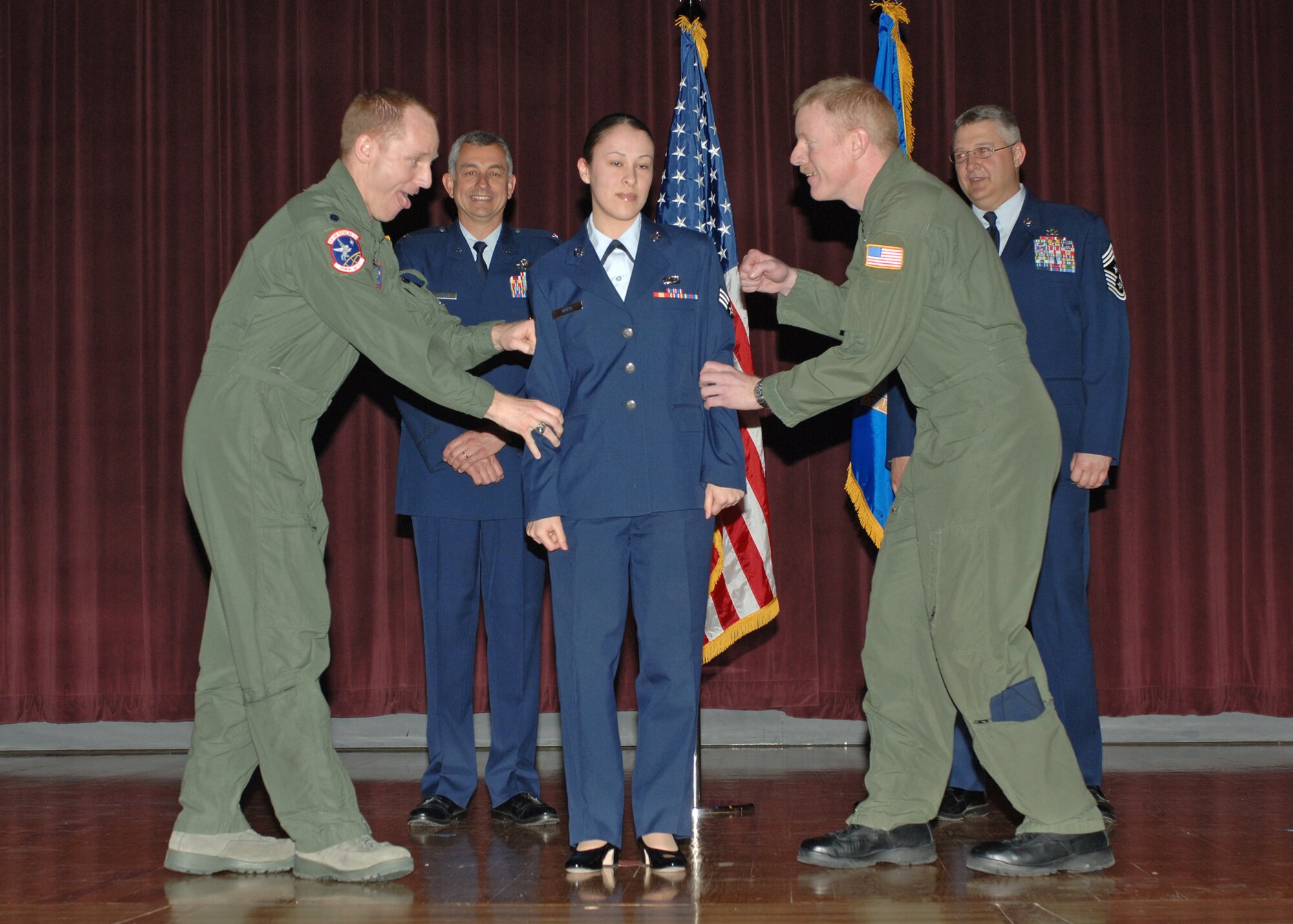 FAIRCHILD AIR FORCE BASE, Wash – Lt. Col. Patrick Rhatigan, 93rd Air Refueling Squadron commander, and Senior Master Sgt. Steven Flax, 93rd Air Refueling Wing Squadron, pin on Heather White’s senior airman stripes during a wing promotion ceremony March 31 at the base theater here. Airmen White earned her senior airman rank six months and pinned on Below the Zone. (U.S. Air Force photo / Airman 1st Class Melissa Barnett)