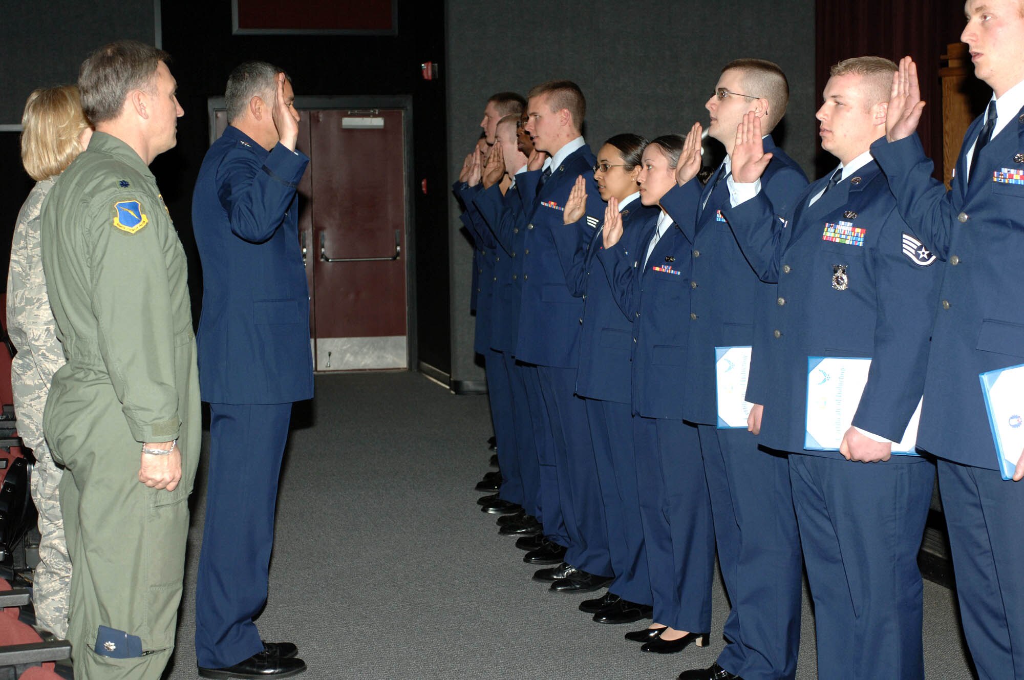 FAIRCHILD AIR FORCE BASE, Wash. – Col. Roger Watkins, acting 92nd Air Refueling Wing commander, administers the enlisted oath to 20 April promotees during a wing promotion ceremony March 31 at the theater here. (U.S. Air Force photo / Airman First Class Melissa Barnett)