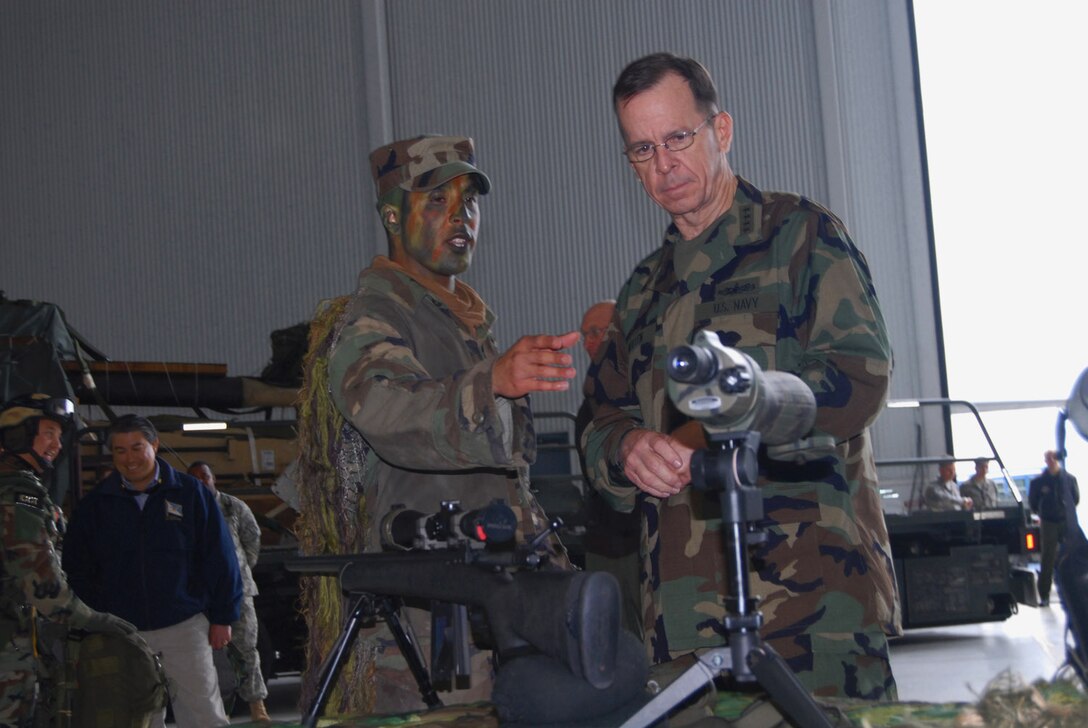 Staff Sgt. Yamil Roman-Rivera, a 43rd Security Forces Squadron Airman, gives a sniper rifle presentation March 31 to Adm. Mike Mullen, chairman of the Joint Chiefs of Staff, during his visit to Pope Air Force Base, N.C. and nearby Fort Bragg.  Airmen from the 43rd SFS also had a military working dog presentation at the expo. (U.S. Air Force photo/Airman 1st Class Mindy Bloem)