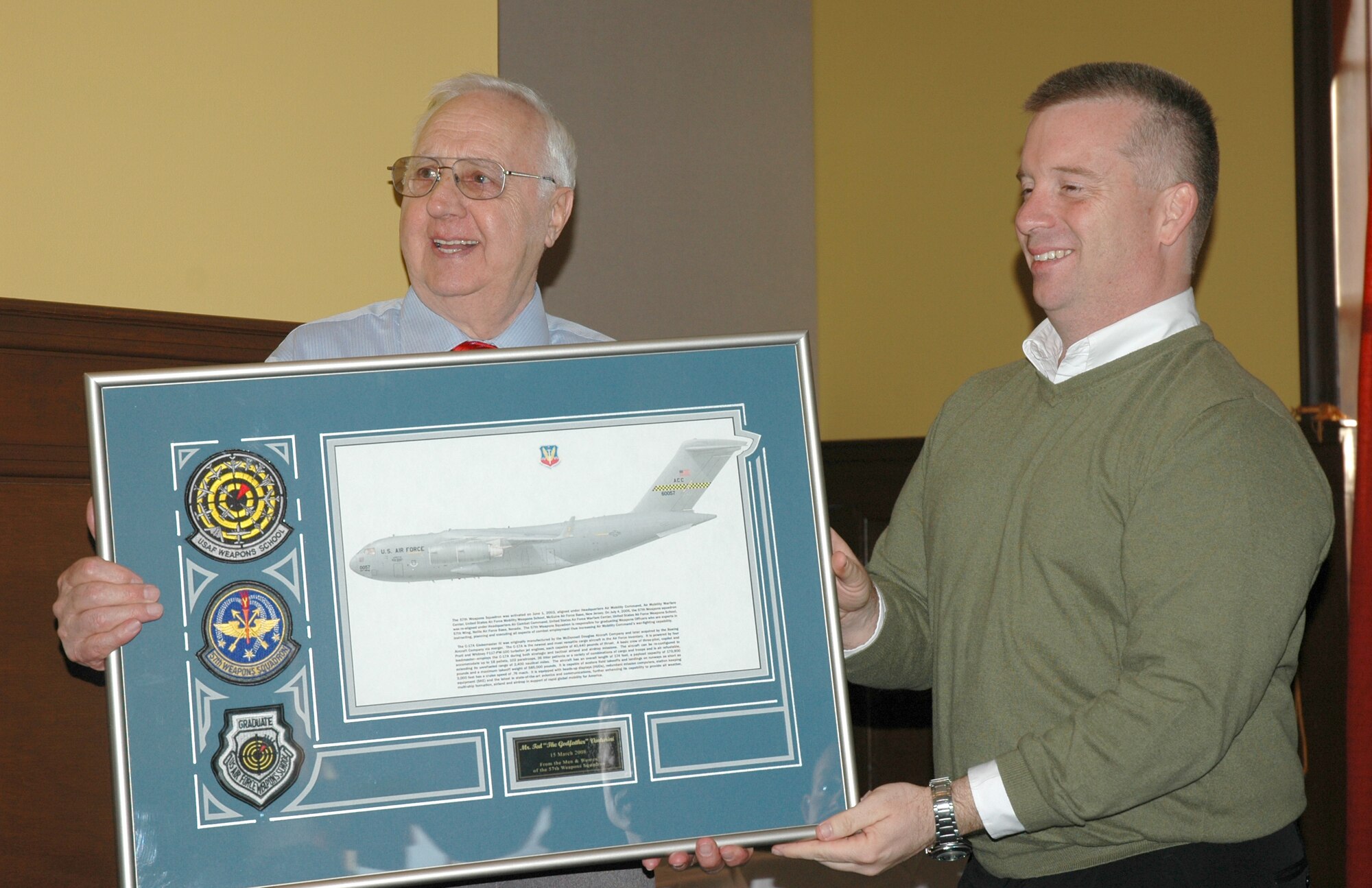 Lt Col Daniels presents Master Sgt. (ret) Ted Venturini with a gift honoring the establishment of the 57th Weapons Squadron Venturini Award. (Courtesy photo)
