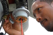 MOODY AIR FORCE BASE, Ga. -- Staff Sgt. Ray Campbell, 723rd Aircraft Maintenance Squadron HH-60G Pave Hawk electrical and environmental craftsman, safety-wires the electrical connector on a rescue hoist here April 1. All critical connectors and bolts on the Pave Hawk are secured with steel safety wire to keep them from falling off. (U.S. Air Force photo by Tech. Sgt. Parker Gyokeres)