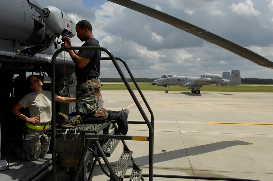 MOODY AIR FORCE BASE, Ga. -- Senior Airman Stephanie Secor and Staff Sgt. Ray Campbell, 723rd Aircraft Maintenance Squadron HH-60G Pave Hawk electrical and environmental technicians, maintain a hoist cable guillotine here April 1 as a Moody-assigned A-10C Thunderbolt II heads out on a training mission. The base is host to HH-60G’s, A-10C’s and HC-130P King aircraft. (U.S. Air Force photo by Tech. Sgt. Parker Gyokeres)