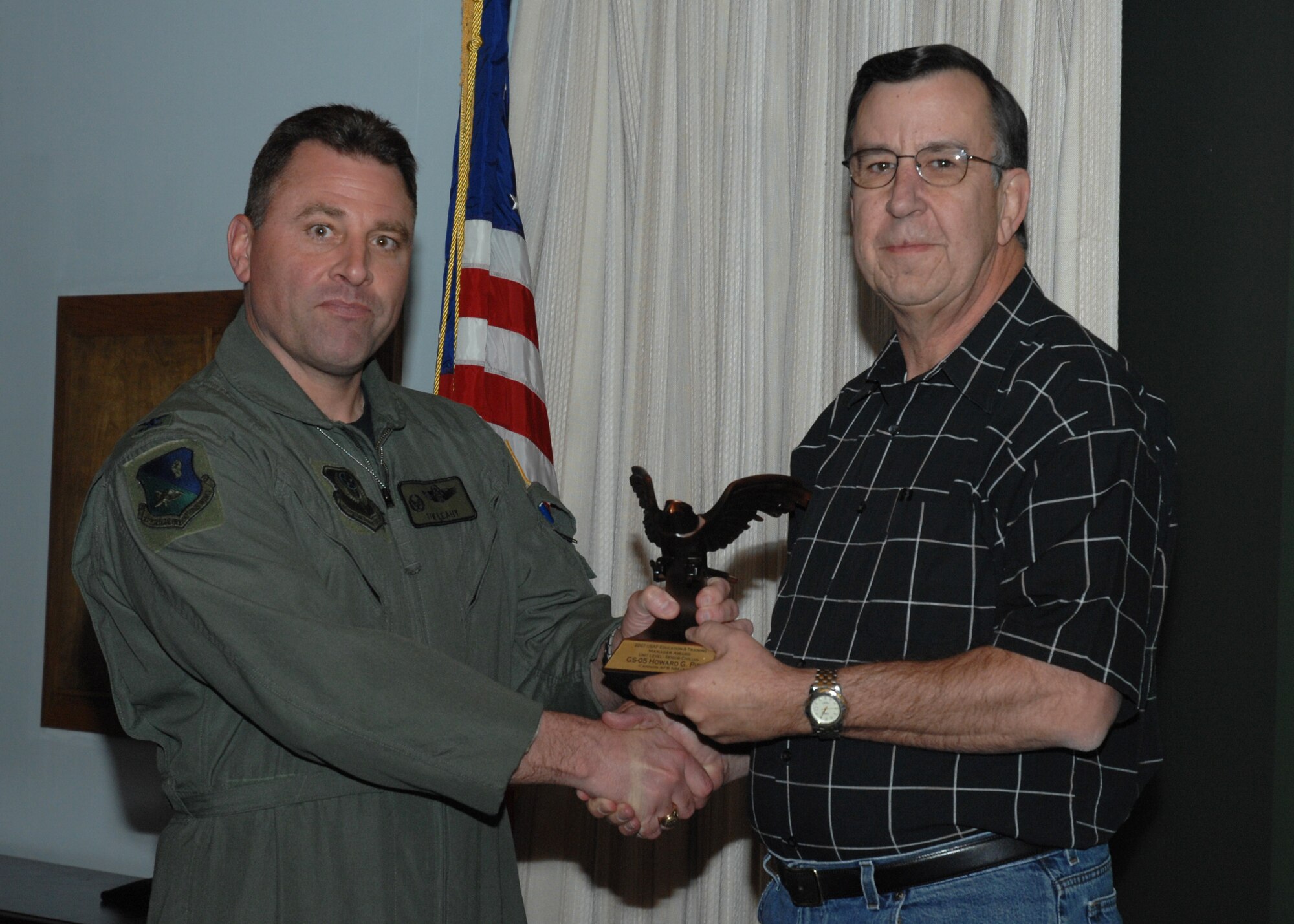 CANNON AIR FORCE BASE, N.M. - Mr. Howard Pipes, 27th Special Operations Logistics Readiness Squadron, receives the Education and Training Manager Award Unit Level - Senior Civilian award April 1 presented by Col. Timothy Leahy, 27th Special Operations Wing commander.  (U.S. Air Force photo by Airman 1st Class Evelyn Chavez)