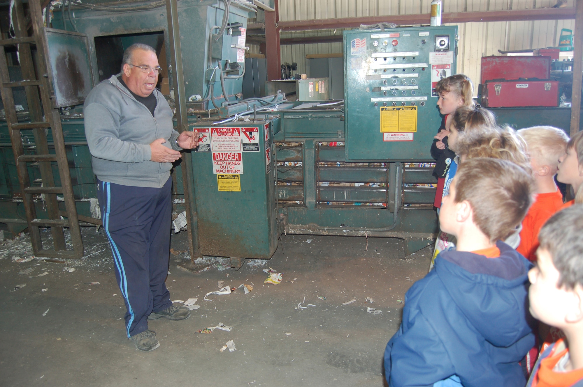 EGLIN AIR FORCE BASE, Fla. -- Steven Leutkehans, Eglin Recycling Center assistant manager, explains how a cardboard bailer works to a group of students from Bob Sikes Elementary School in Crestview, Fla., in the Eglin Recycling Center Thursday.  Over the course of three days, more than 160 students, parents and teachers from the school toured the Eglin Recycling Center to learn more about how Eglin recycles various materials. (U.S. Air Force photo/ Jerron Barnett)
