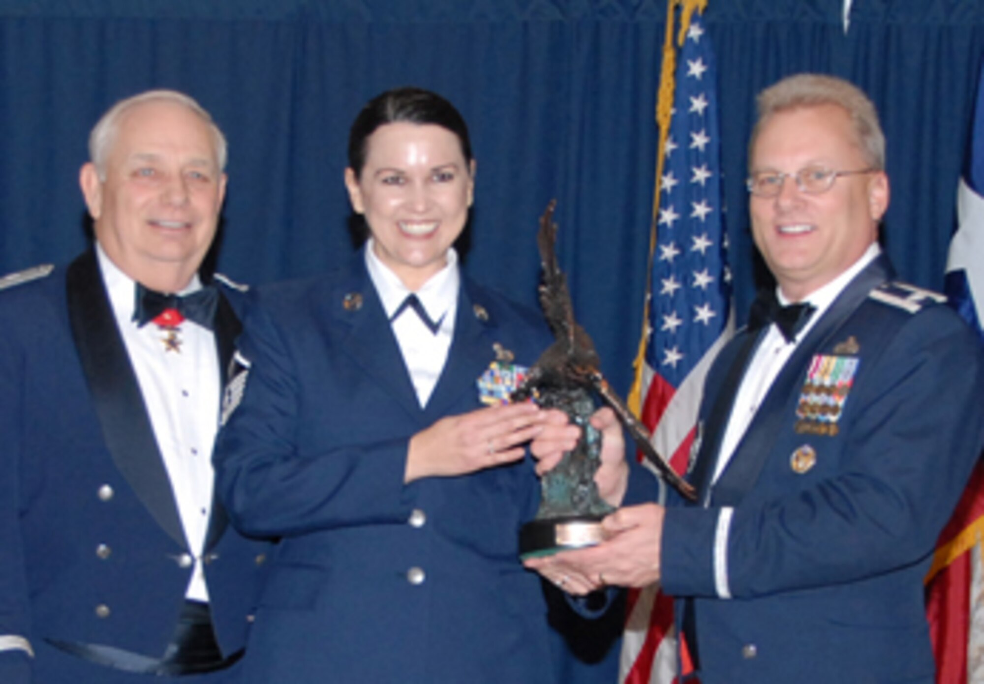 Maj. Gen. Allen Dehnert, Commander of the Texas Air National Guard, and LtCol Randy Johnson, Chief of Recruiting and Retention for the National Guard Bureau present Master Sgt. Cindy Matzen with the Unit Career Advisor of the year award for  2007.  Matzen of the 209th Weather Flight at Camp Mabry in Austin, was selected for the award from among her UCA peers throughout the state and recognized during the Recruiting and Retention conference held in Corpus Chirsti in February. 