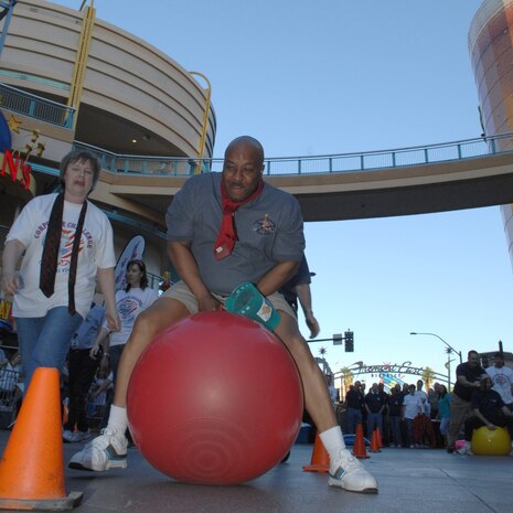 LAS VEGAS -- Chief Master Sgt. Vernon Boardley, 99th Mission Support Group chief enlisted manager, participates in a executive relay event during the beginning of the Las Vegas Corporate Challenge March 26. Team Nellis placed sixth in the executive relay event with a time of three minutes and 40 seconds.(U.S. Air Force Photo/Senior Airman Larry E. Reid Jr.)