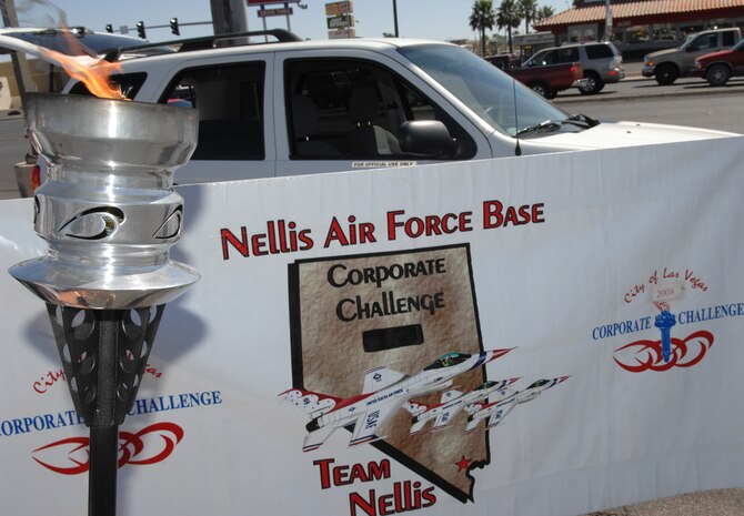 LAS VEGAS -- Team Nellis receives the torch in preparation for their run during the Las Vegas Corporate Challenge torch relay March 26. (U.S. Air Force Photo/Senior Airman Larry E. Reid Jr.)