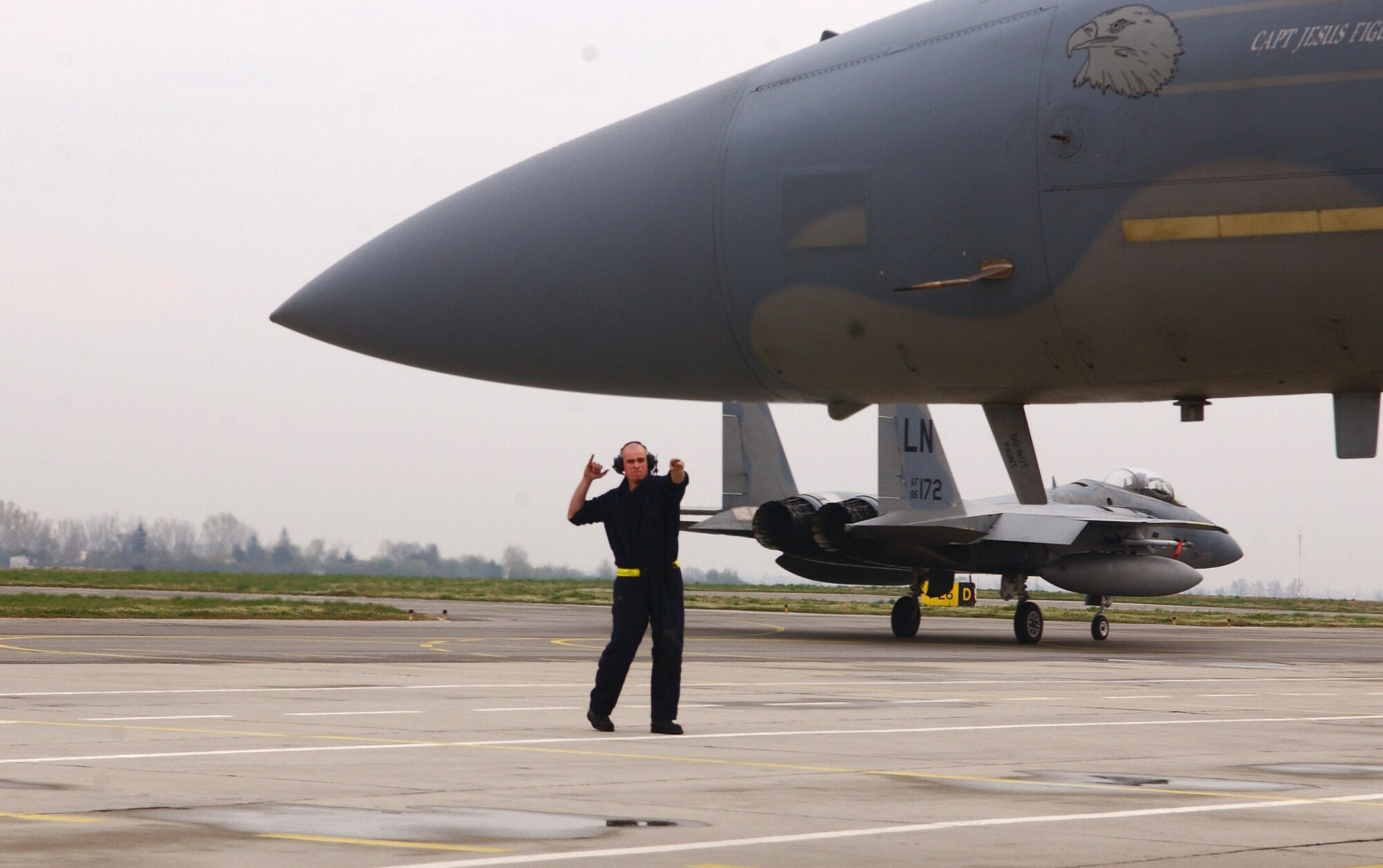 Airman 1st Class Daniel Addabbo marshals an F-15 Eagle for an Operation Noble Endeavor mission April 1 at Graf Ignatievo Air Base, Bulgaria. F-15s deployed from Royal Air Force Lakenheath, England, are projecting airpower in support of the NATO summit in Bucharest, Romania. Airman Addabbo is a 493rd Expeditionary Fighter Squadron assistant crew chief. (U.S. Air Force photo/Tech. Sgt. J. LaVoie) 

