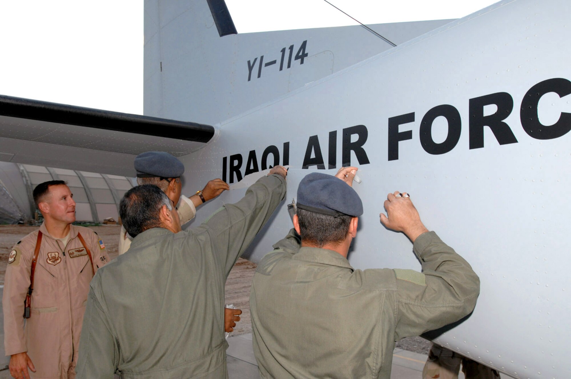 Iraqi pilots remove tape off a new Cessna 208 Caravan to reveal the Iraqi air force markings March 29 at Kirkuk Air Base, Iraq. The Cessna 208 is the advanced fixed wing training aircraft for the Iraqi Flying Training Wing. Iraqi students spend approximately six months learning to fly the Cessna and receive pilot wings upon completion of the training syllabus. They then move onto the Iraqi air force's operational aircraft which includes the C-208, King Air, C-130 Hercules or SAMA (Zenair) CH-2000. The Iraqi Air Force Flying Training Wing inventory will have a total of five Cessna 208s by the end of 2008. (U.S. Air Force/Senior Master Sgt. Don Senger) 