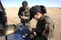 MINOT AIR FORCE BASE, N.D.-- Senior Airman Christine Green, an explosive ordnance disposal apprentice, and Tech. Sgt. Tobin Bryant, an EOD craftsman, both from the 5th Civil Engineer Squadron, pack composition C-4 plastic explosive into the bottom of a bottle during an EOD training exercise here March 26. Base EOD members, along with bomb squad members from Minot, participated in several scenarios as part of the training. (U.S. Air Foce photo by Senior Airman Cassandra Jones)