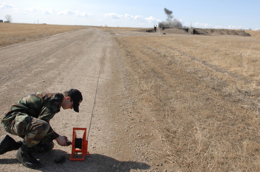 MINOT AIR FORCE BASE, N.D.-- Senior Airman Ryan Johnson, an explosive ordnance disposal support apprentice from the 5th Civil Engineer Squadron, detonates a composition C-4 plastic explosive during an EOD training exercise here March 26. Base EOD members, along with bomb squad members from Minot, participated in several scenarios as part of the training. (U.S. Air Force photo by Senior Airman Cassandra Jones)