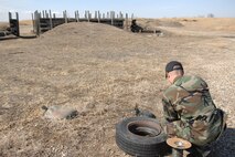 MINOT AIR FORCE BASE, N.D.-- Tech. Sgt. Tobin Bryant, an explosive ordnance disposal craftsman from the 5th Civil Engineer Squadron, remotely fires a shotgun shell at a training pipe bomb during an EOD training exercise here March 26. Base EOD members, along with bomb squad members from Minot, participated in several scenarios such as disarming pipe bombs and detonating C-4 explosives. (U.S. Air Force photo by Senior Airman Cassandra Jones)