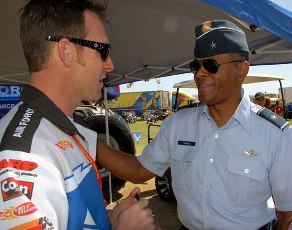 LAS VEGAS -- Brig. Gen. Everett H. Thomas, United States Air Force Warfare Center vice commander, gets briefed on the Air Force Afterburner monster truck by its driver, Damon Bradshaw, on March 29.  Afterburner and Mr. Bradshaw were in Las Vegas to compete in the Monster Jam world finals.  General Thomas conducted a swearing-in ceremony for more than 20 new Air Force members at the event. (U.S. Air Force photo/Chief Master Sgt. Gary Emery)