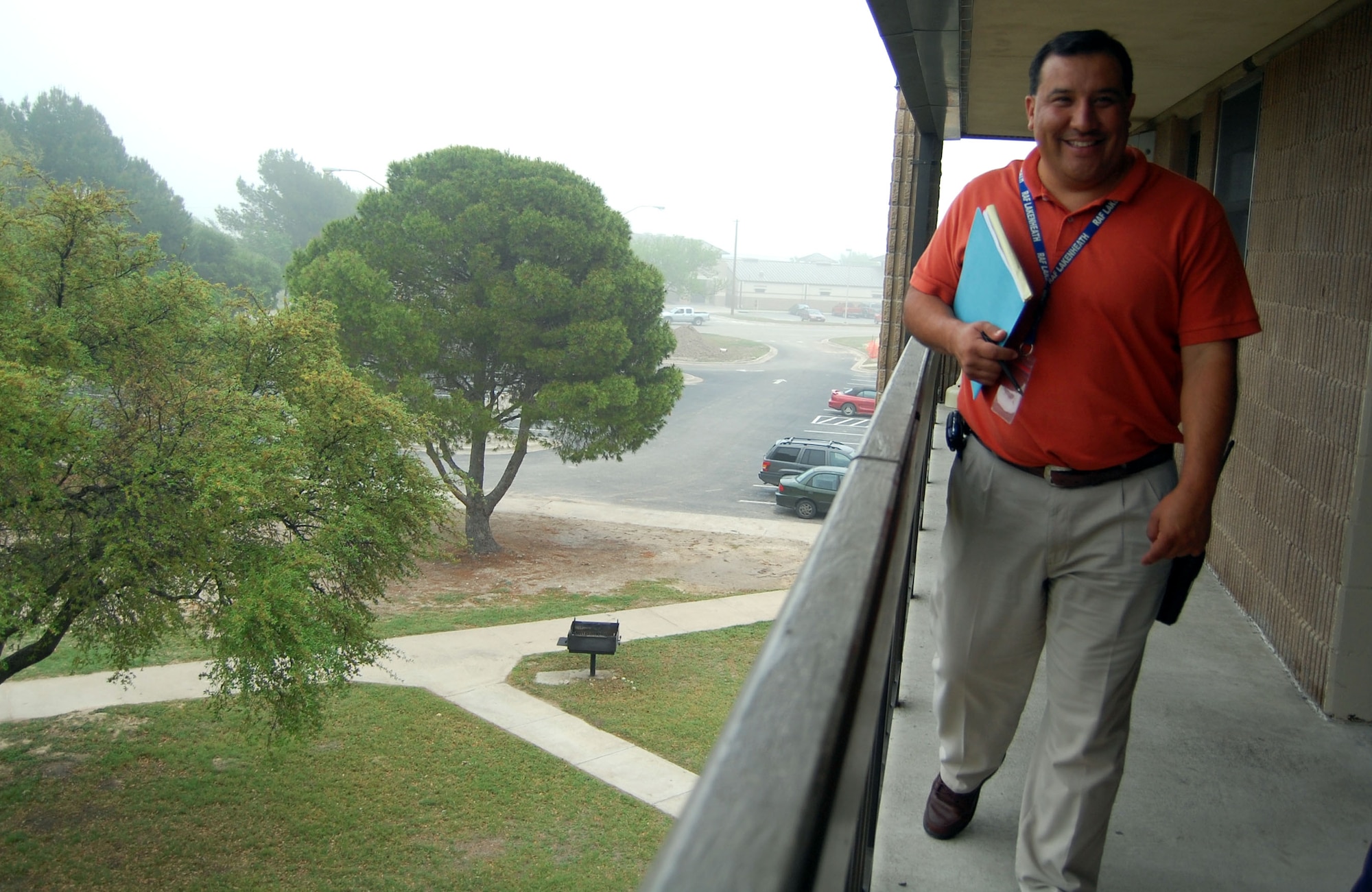 LAUGHLIN AIR FORCE BASE, Texas – Javier Cardenas, enlisted dorm manager with the 47th Civil Engineer Squadron, walks along the third floor balcony of building 256 during quarterly dormitory room inspections April 1. Cardenas was recently appointed to the dorm manager after spending five years in the housing division. As the dorm manager, he in and out-processes Airmen, resolves all issues with dorm rooms and is responsible for the general care of the two buildings. “I’m very excited for this new challenge,” said Cardenas. “I’m going to enjoy taking care of the Airmen.” U.S. Air Force photo by Airman 1st Class Sara Csurilla)