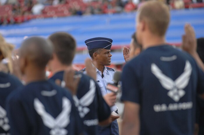Brig. Gen. Everett Thomas, Vice-Commander, United States Air Force Warfare Center, Nellis Air Force Base, Nev., administers the oath of enlistment to future airmen currently in the delayed enlisted program, before the start of the Monster Jam World Finals at Sam Boyd Stadium Las Vegas, Nev., March 29, 2008. (U.S. Air Force Photo by/Senior Airman Larry E. Reid Jr.)(Released)