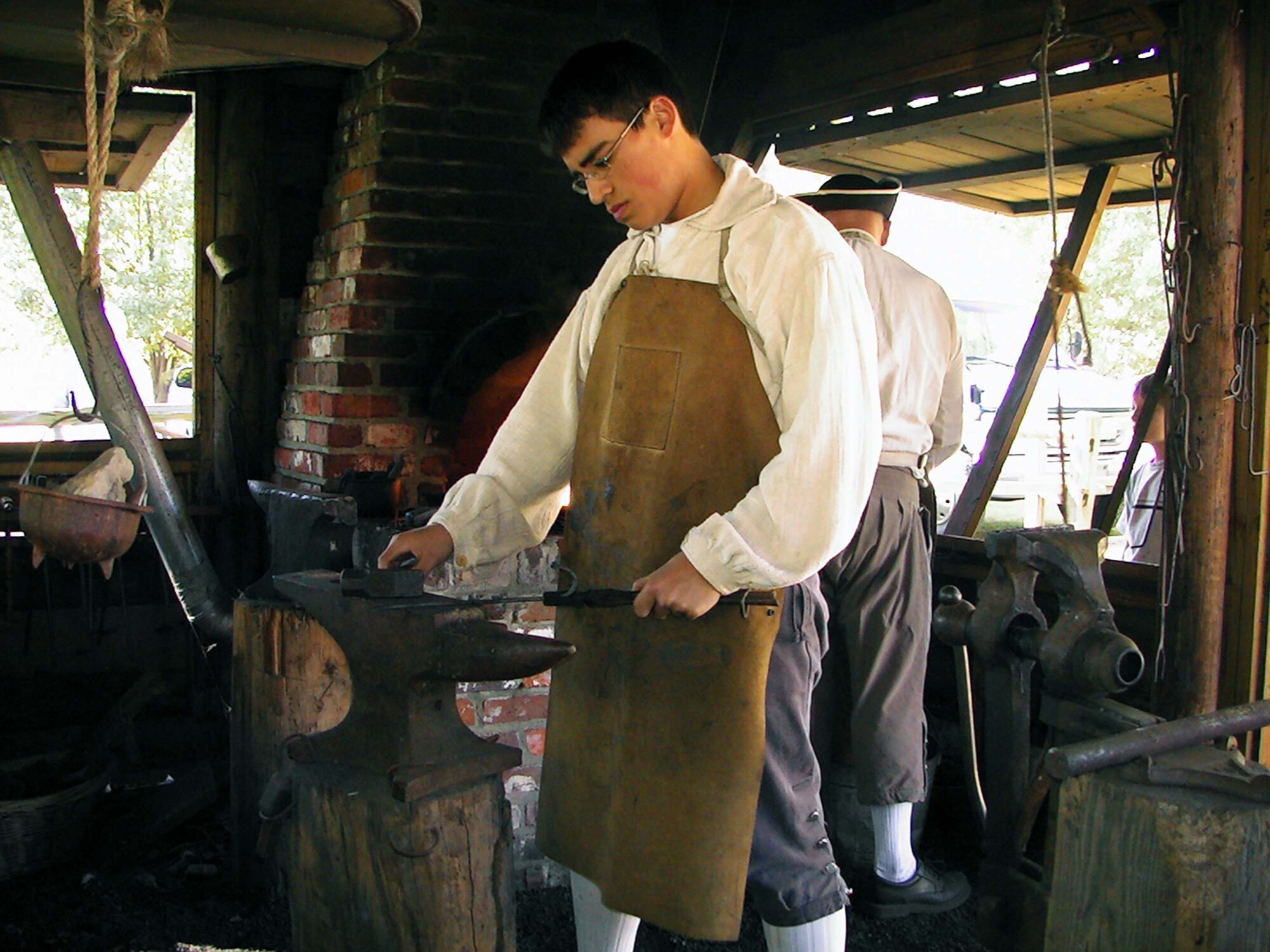 SUMTER, S.C. -- Christian "Storm" Smith, son of Lee and Master Sgt. Scotti Smith, 9th Air Force, performs blacksmith duties April 7 during the Back Country Days in the Sumter County Museum. The Back Country Days is a bi-annual event and Storm volunteers for every occurance. Community involvement has helped Christian earn Shaw's Youth of the Year Award. (courtesy photo)
                   