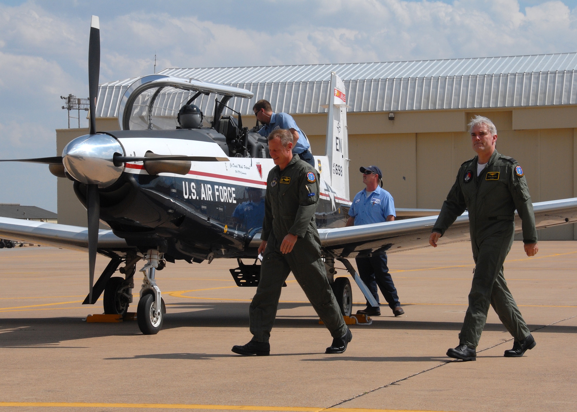 Col. David Petersen, left, 80th Flying Training Wing commader, and Royal Netherlands Air Force Air Commodore Peter Berlijn make their way to the official T-6A Texan II arrival ceremony March 31 after landing in the wing's newest training aircraft. Sixty-nine Texan IIs will replace 74 T-37 Tweets over the next 18 months. (U.S. Air Force photo/Mike Litteken)