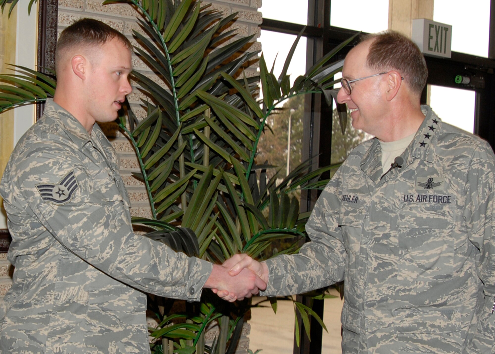 Gen. C. Robert Kehler, Air Force Space Command commander, meets Staff Sgt. Brooks Jones, 21st Security Forces Squadron dog handler, before the commander’s call March 28. Sergeant Jones was awarded the Air Force Combat Action medal by General Kehler during the commander’s call. (U.S. Air Force photo/Roberta McDonald)