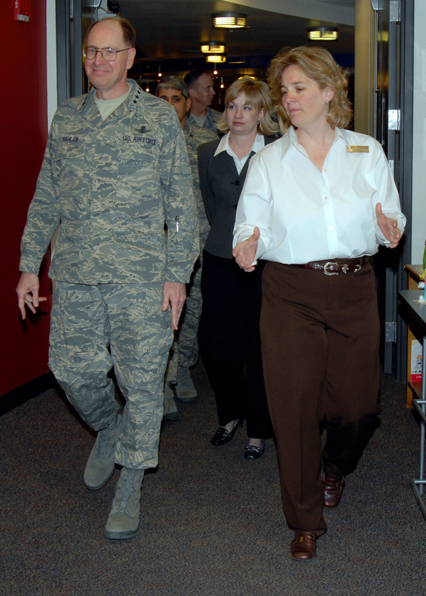 Jane-Marie Kopycinski, R.P. Lee Youth Center director of youth programs, talks with Gen. C. Robert Kehler, Air Force Space Command commander, about the changes the youth center underwent after his time as the 21st Space Wing commander during the general’s visit March 28. (U.S. Air Force photo/Roberta McDonald)