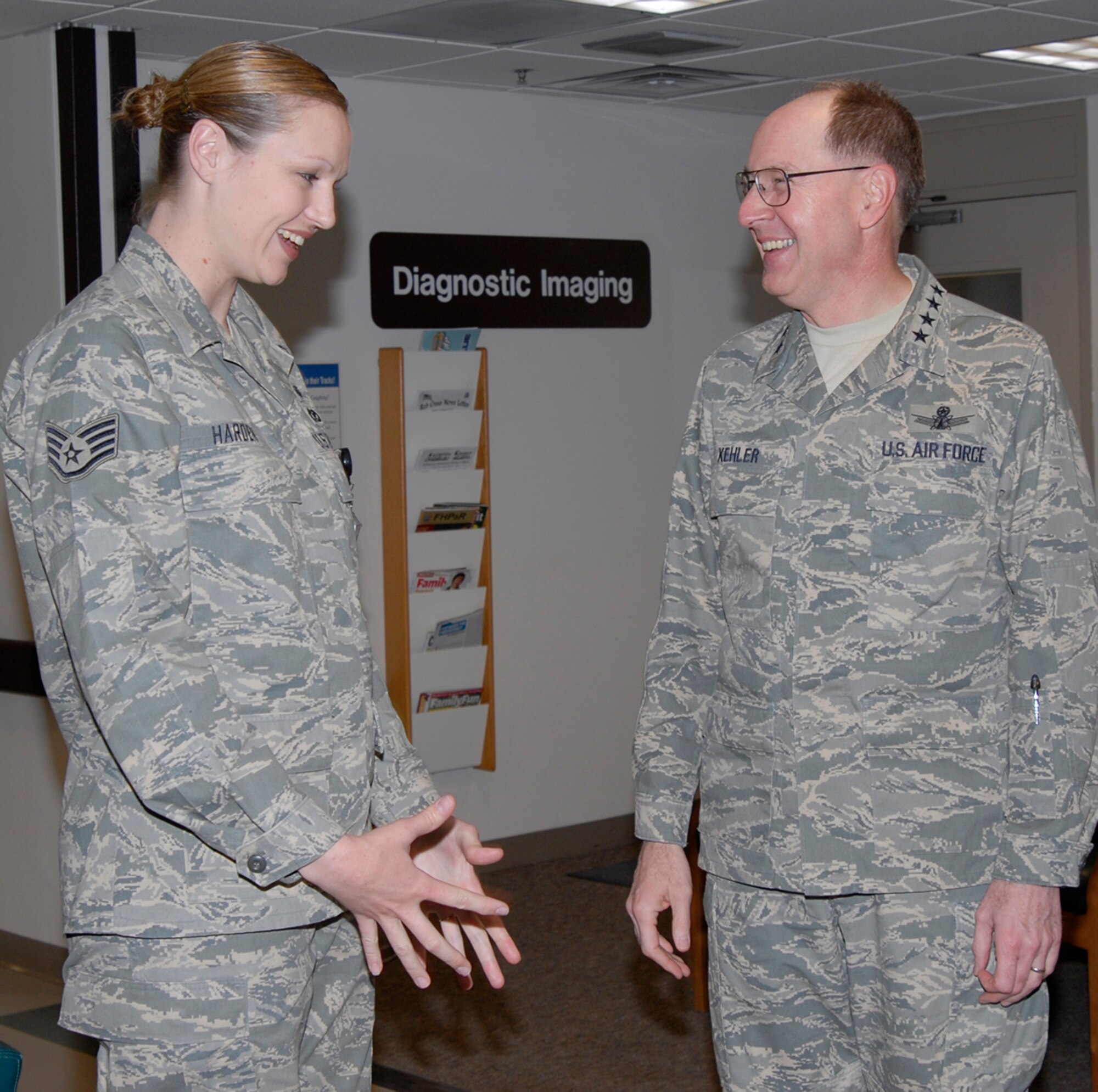 Staff Sgt. Candice Harden, 21st Medical Support Squadron laboratory technician, talks with Gen. C. Robert Kehler, Air Force Space Command commander, about what her job entails during the general’s visit March 28. (U.S. Air Force photo/Roberta McDonald)